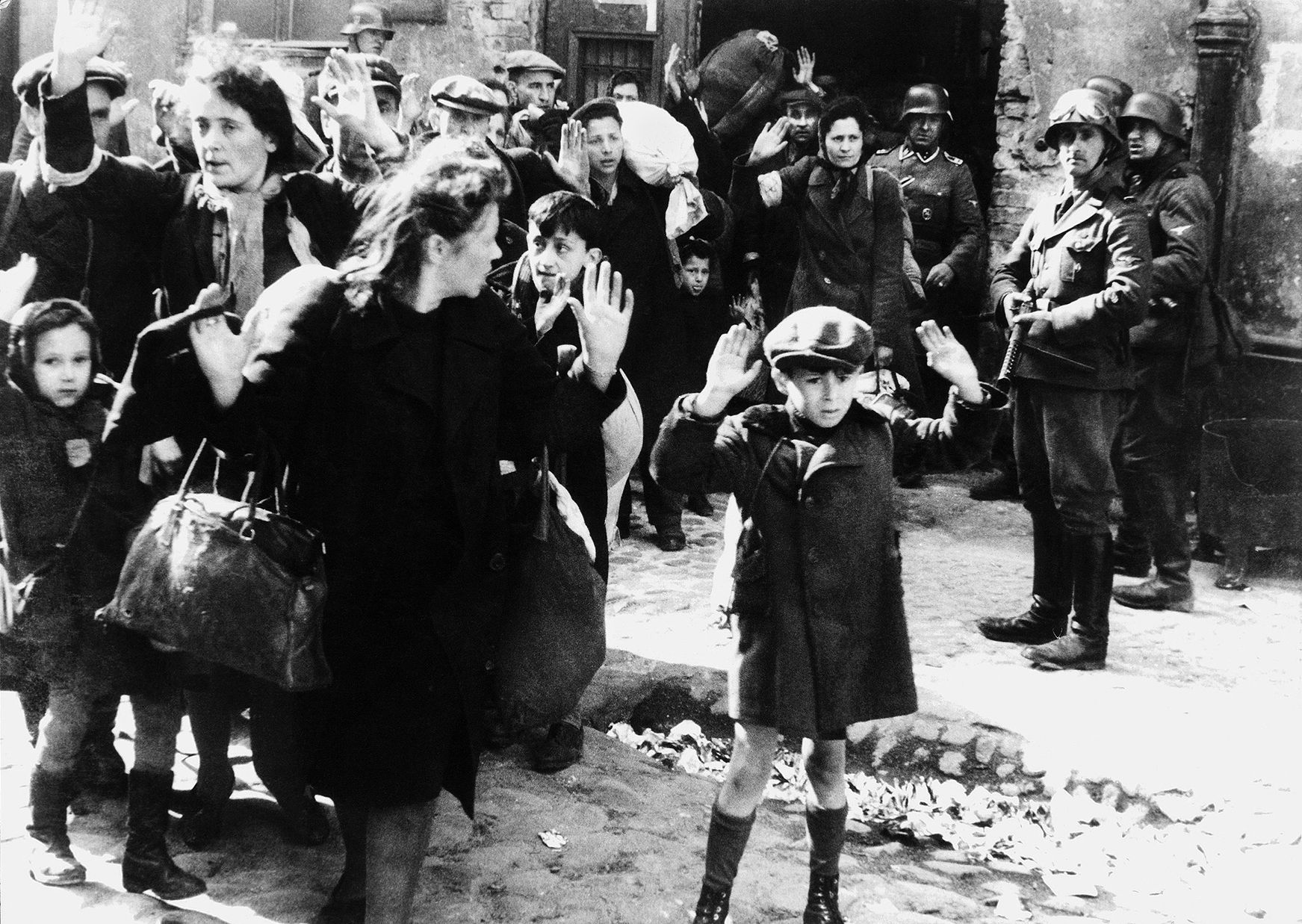 Terror is reflected in the eyes of these Polish Jews and other civilians as they are rounded up by German soldiers and destined for a concentration camp. Henry Zguda became a political prisoner of the Nazis and spent months in captivity.