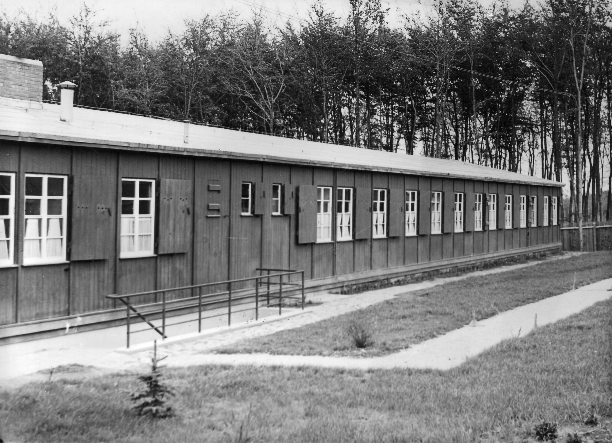 This side view of the bordello building at the Buchenwald concentration camp reveals curtains in each window. This photo was taken at the camp in 1943. 