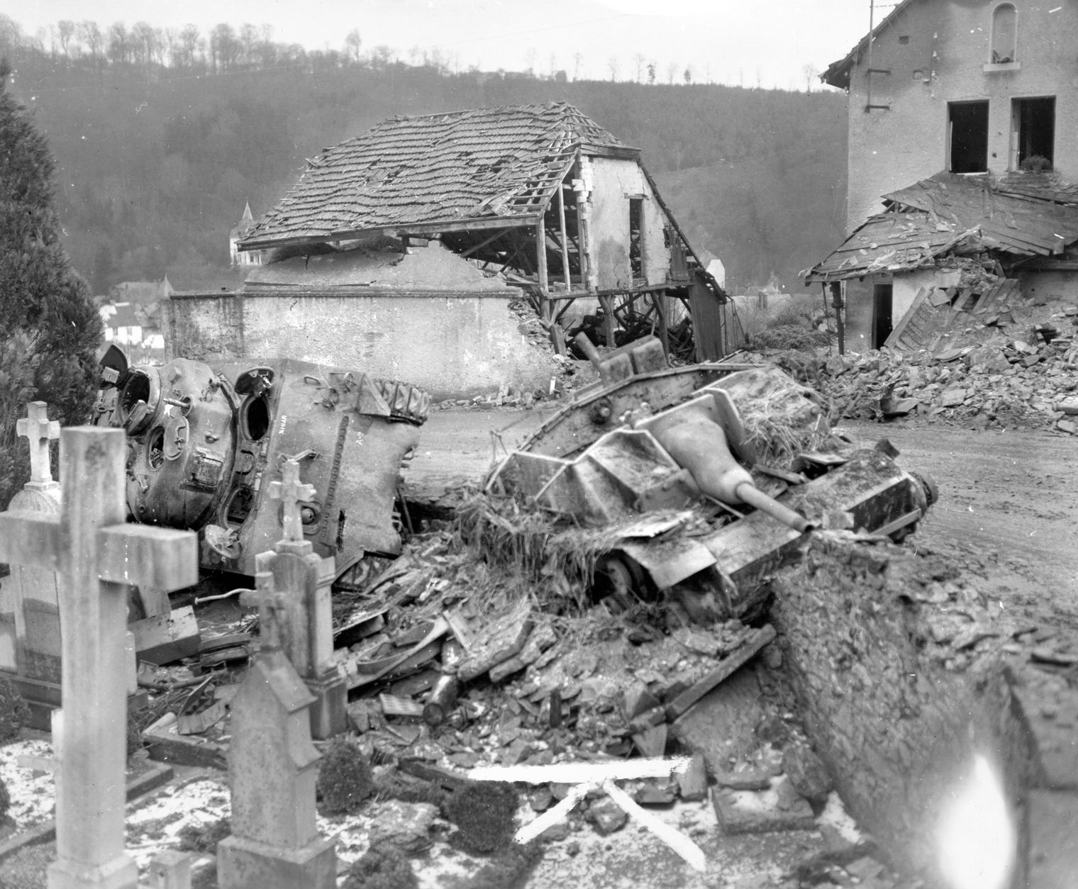 The hulks of a knocked-out German Sturmgeschutz III self-propelled assault gun and an American M4 Sherman tank from the 707th Tank Battalion bear mute testimony to the ferocity of the fighting adjacent to a cemetery on the outskirts of the town of Clervaux, Luxembourg. 