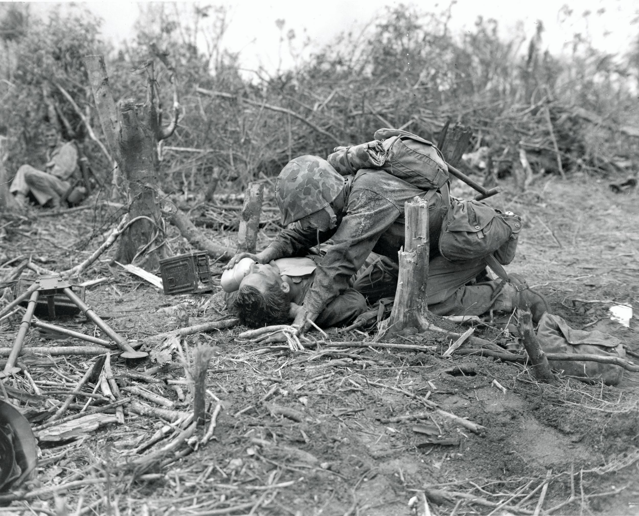 A Marine shares his water with a badly wounded fellow Marine during the fight for Peleliu. Although less well known than Guadalcanal, Iwo Jima, and Okinawa, the battle was no less brutal.