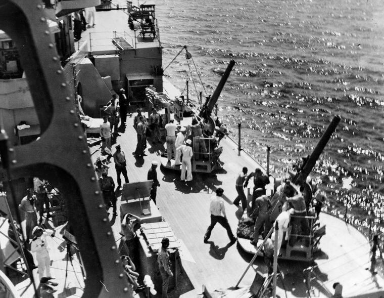 The starboard 5/25 anti-aircraft gun crews of the cruiser USS Houston swing into action during anti-aircraft drills off the coast of China. The Houston crew fought bravely against superior Japanese forces in the East Indies.