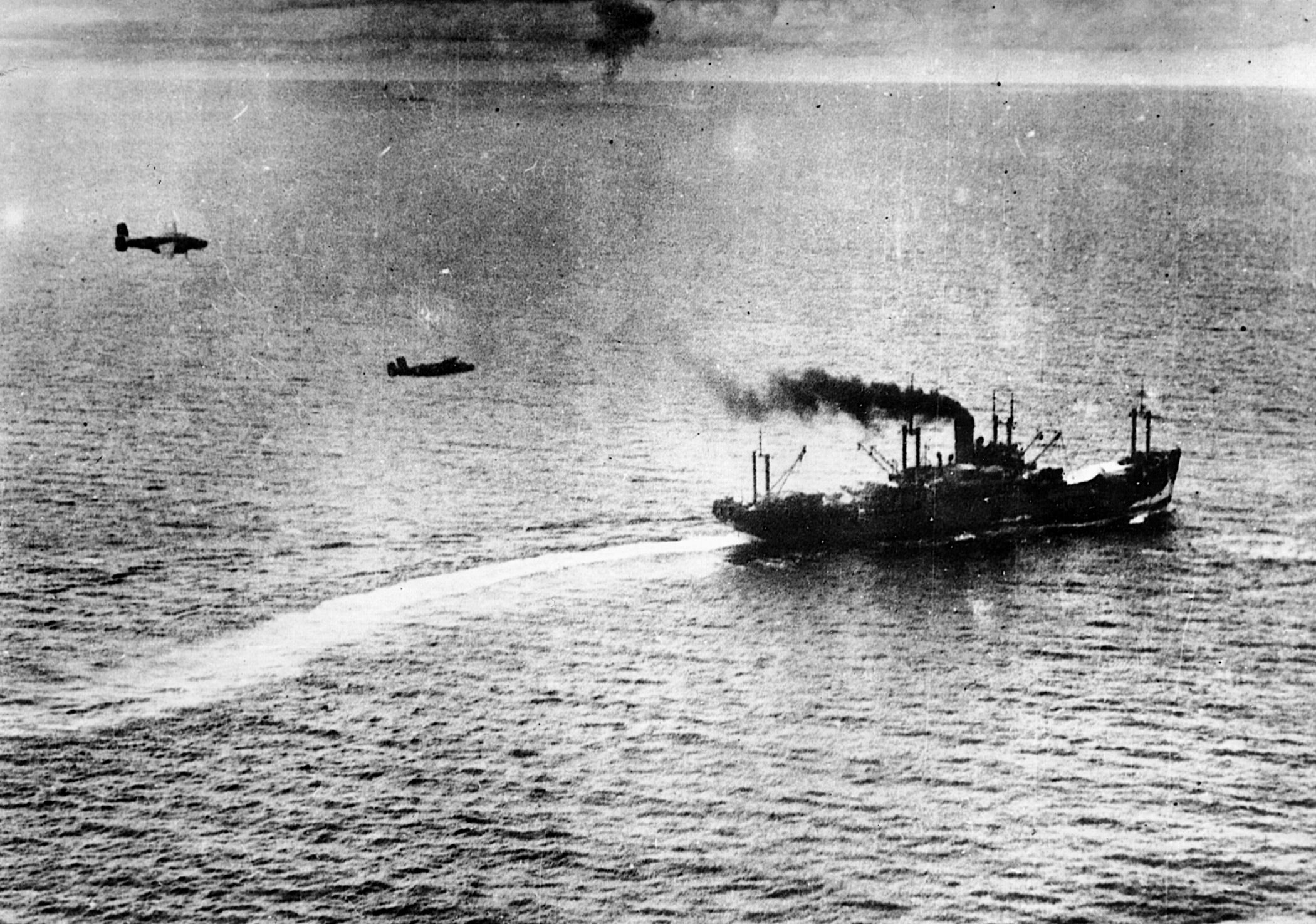 A pair of U.S. medium-range bombers prepares to drop its payload on a Japanese merchant ship during the Battle of the Bismarck Sea.