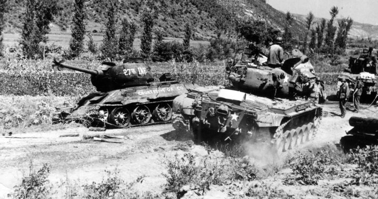 An American M-26 Pershing tank of the 89th Medium Tank Battalion passes a Russian-made North Korean tank destroyed by Fox Company of the U.S. Army’s 27th Infantry Division during the retreat of North Korean forces in August 1950.