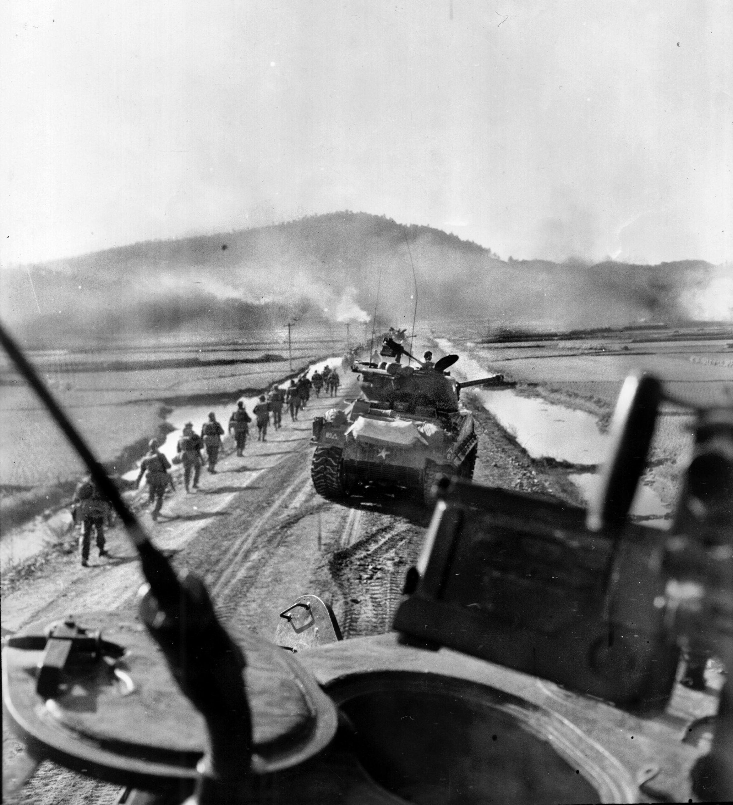 American tanks from the 89th Tank Battalion fire on enemy targets while troops from the British 62st Middlesex Regiment advance against the North Koreans. 