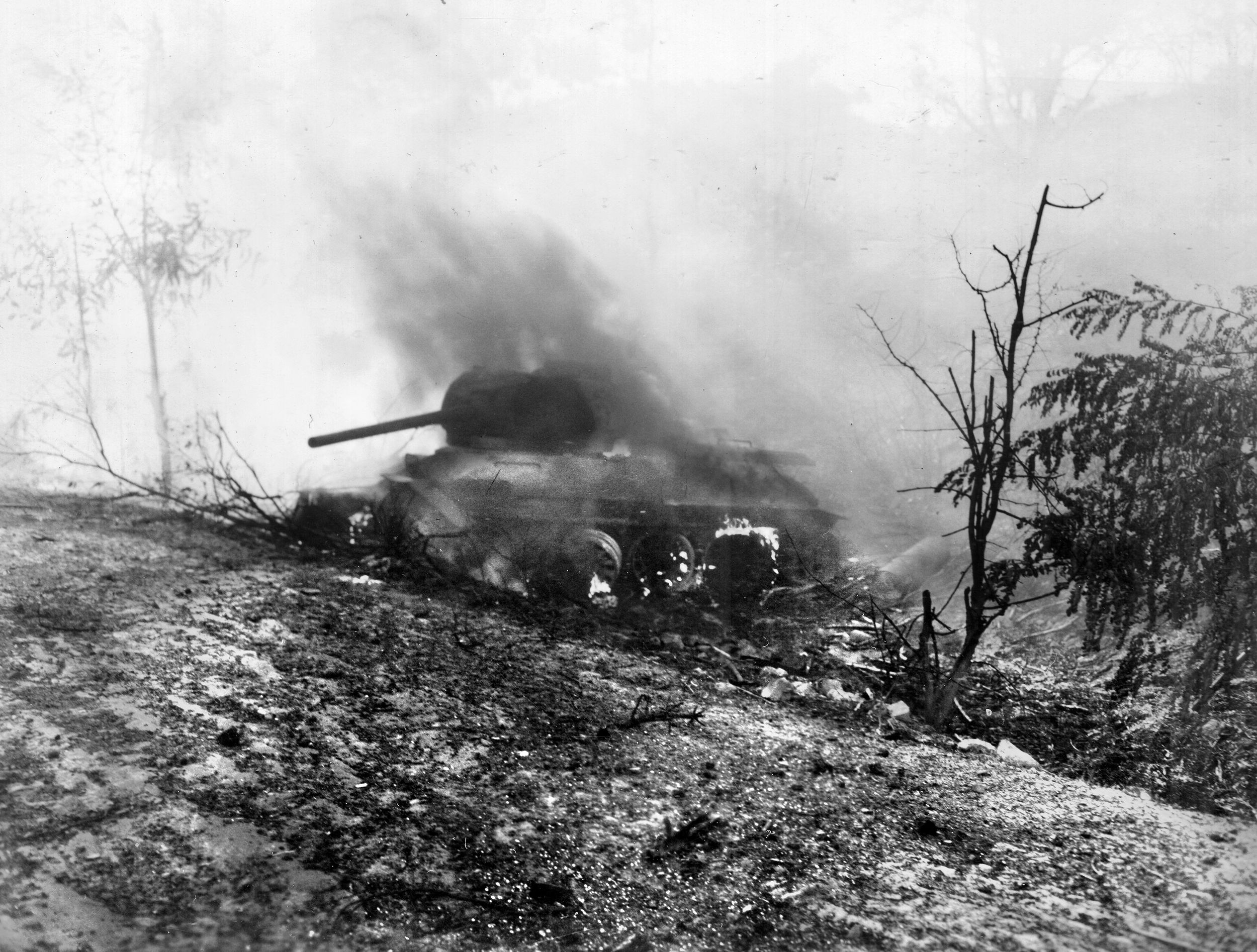 A North Korean tank, mostly likely one of the hundreds of T-34/85s supplied by the Soviet Union, burns by the side of the road, knocked out by the 89th Tank Battalion in the fall of 1950. Though U.N. forces led by the U.S. Eighth Army all but defeated the North Korean People’s Army, the arrival of hundreds of thousands of Chinese troops in October turned the tide of the conflict in the brutal winter of 1950-51.  