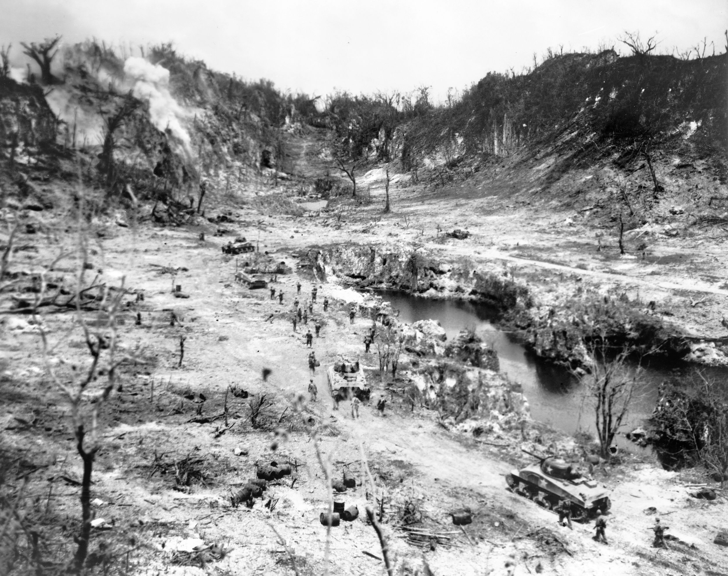 Marine riflemen and tanks in the Horseshoe Ridge area of Peleliu's Umurbrogol massif pass the island’s only source of fresh water. The rugged terrain and fortified tunnels meant that the fight for the Umurbrogol Pocket, taken over by the 7th Marines and the Army’s 81st Division, would last more than two months.