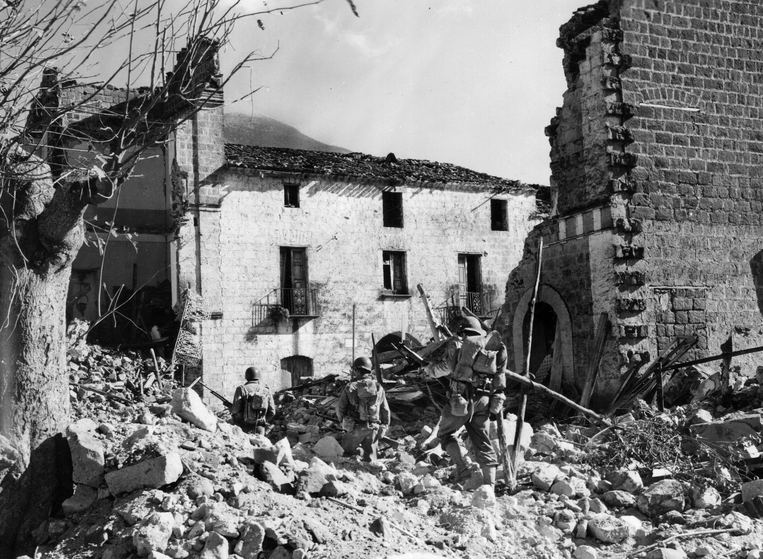 A three-man patrol from Company I, 15th Infantry, picks its way through the rubble of Mignano, south of Cassino, November 1943. Before Cassino and the Gustav Line fell, the 3rd spearheaded the Anzio invasion.