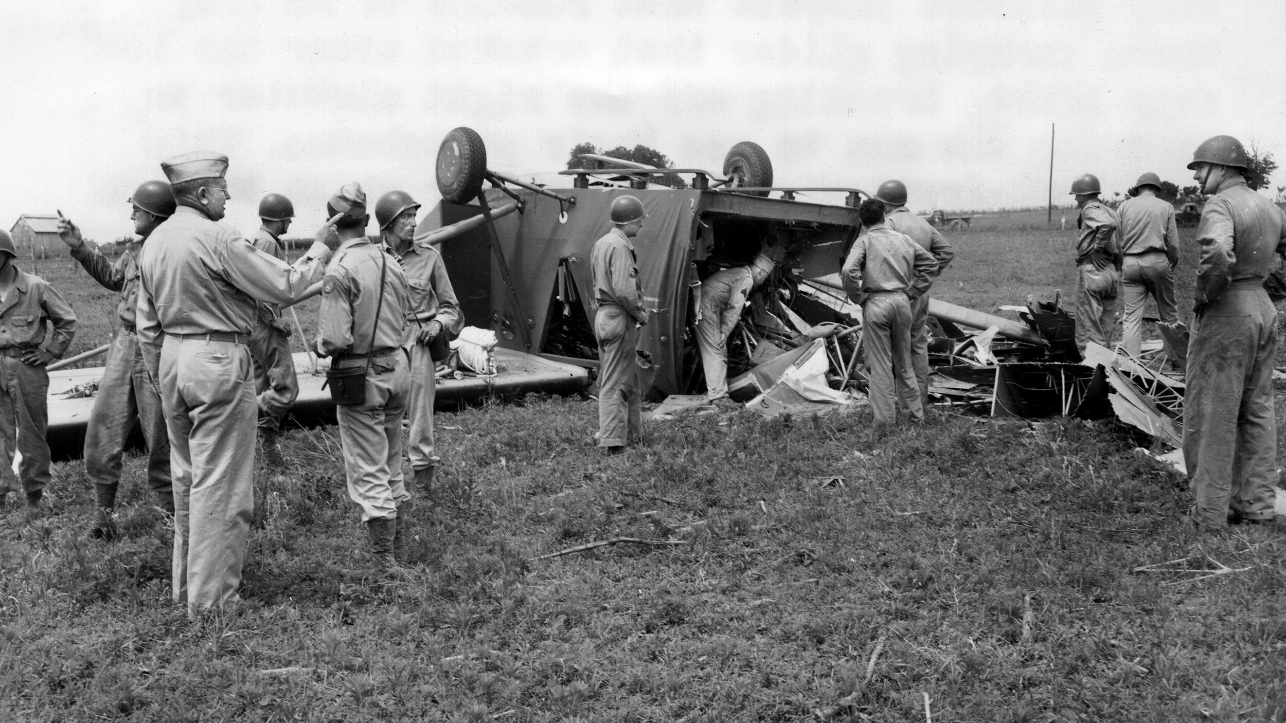 Officers inspect the wreckage of a 101st Airborne glider that flipped upon landing during training in Tennessee, June 1943. The men inside reportedly parachuted to safety.