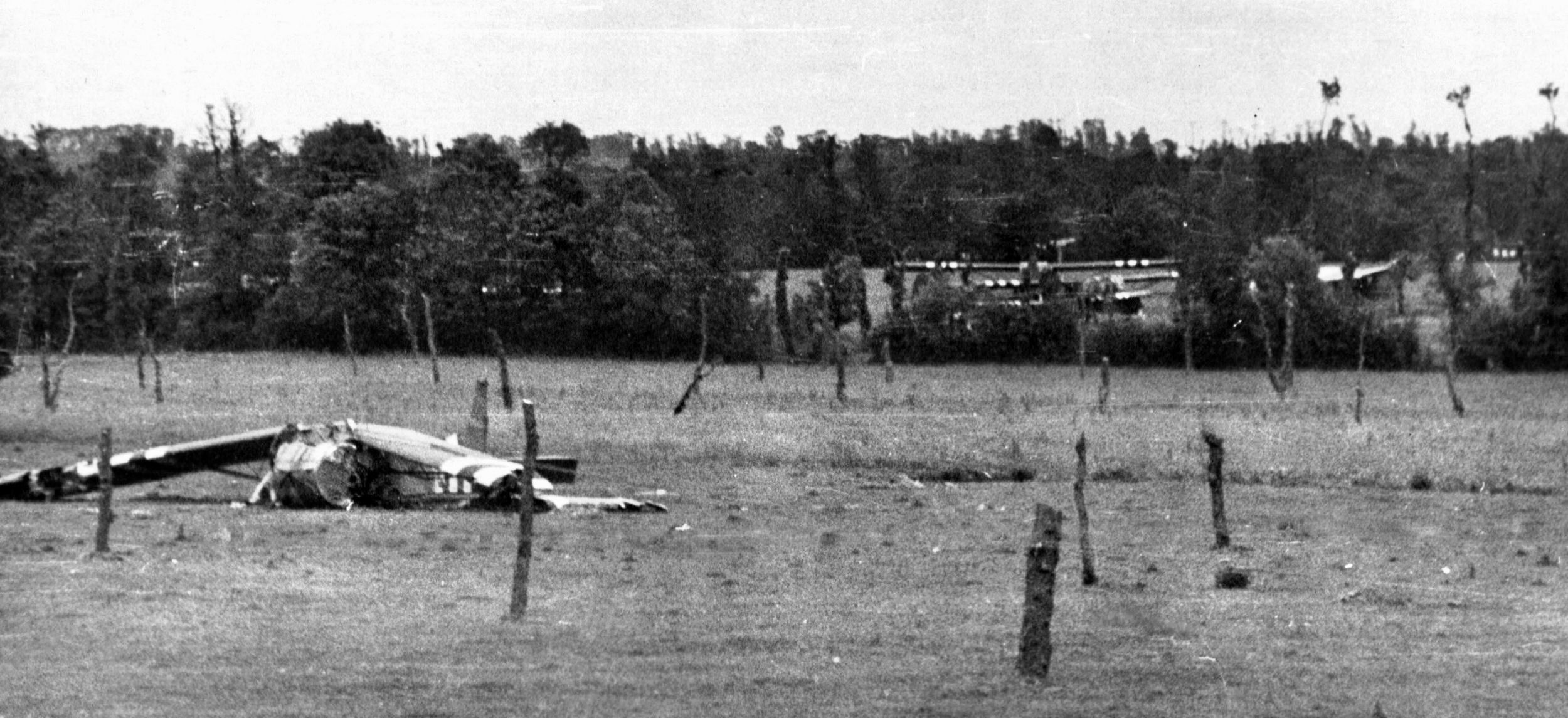 A wrecked glider in a Normandy field near St. Mere Eglise fell victim to “Rommel’s Asperagus” — posts in the ground to destroy landing gliders and their cargo. 