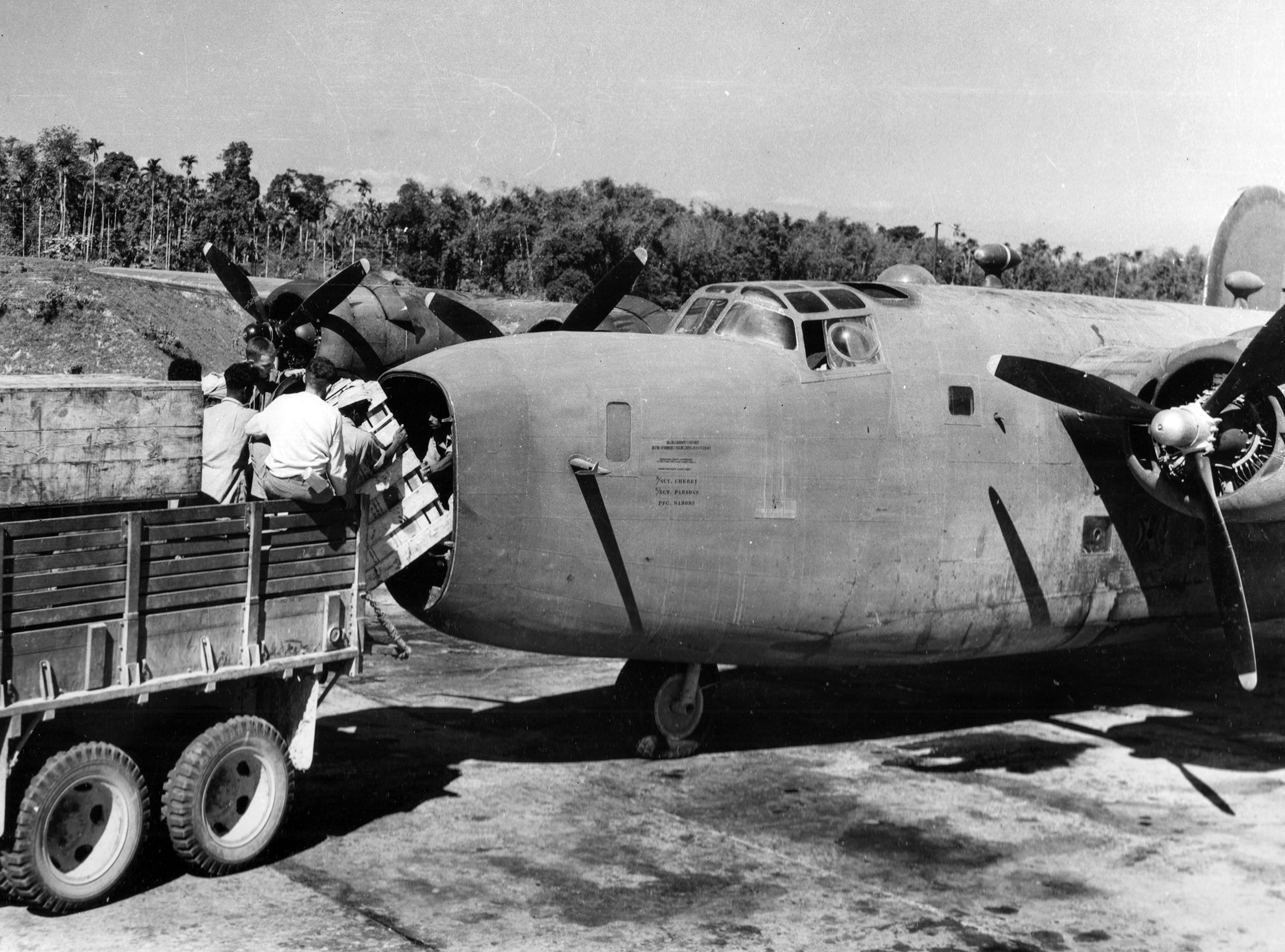 Men transfer naval stores from a truck into the nose of a Consolidated C-87 for shipment to China. The nose of this plane provides cargo space for three drums of gasoline and a 500-pound bomb or its equivalent. 