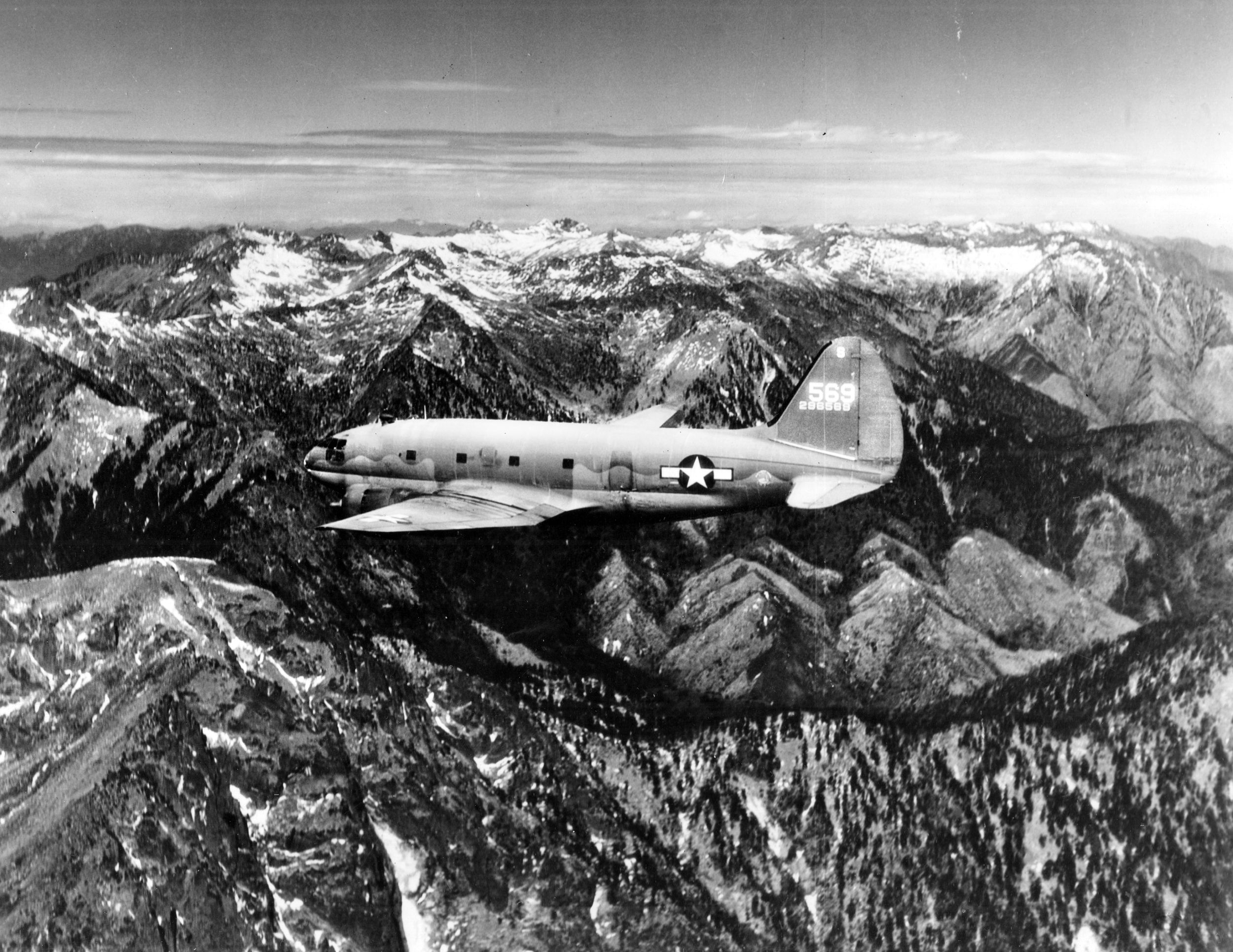 Curtiss C-46 Commando in the snow-capped Himalayas between India and China. Every two and a half minutes, the India-China Division of ATC puts a plane across this route.
