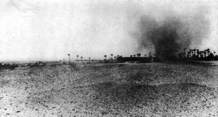 Smoke rises as Leclerc’s Free French force and the British Long Range Desert Group assault the Italian garrison at Murzuk, February 1941.