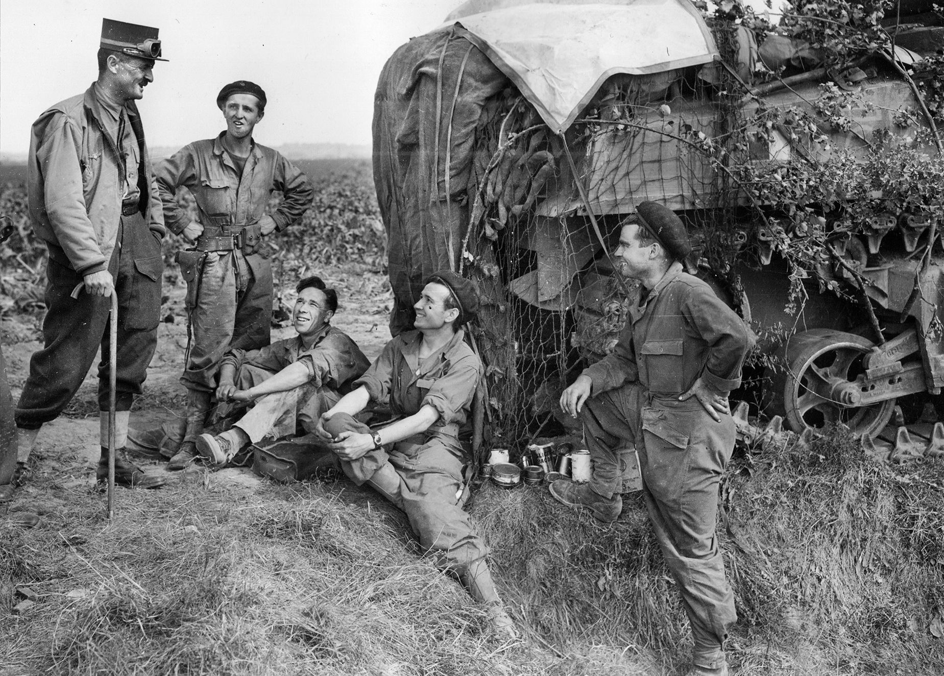 Popular with his men, Leclerc talks to the crew of a Sherman tank. In 1931, Leclerc was injured in a horse-riding accident and thereafter walked with a cane. 