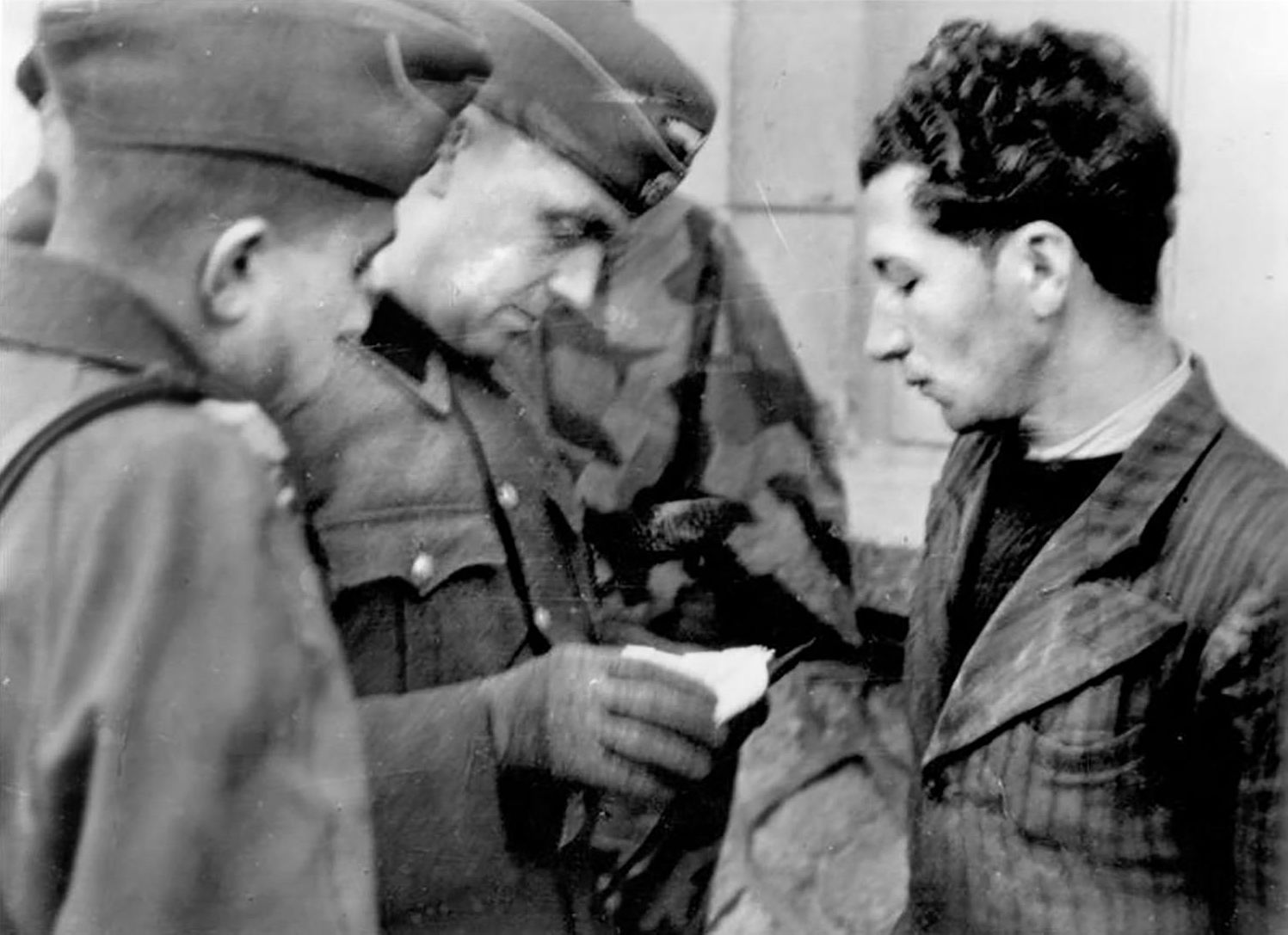 German soldiers arrest a French communist Résistance organizer. In Oradour, Martial Machefer, known locally as a communist sympathiser, was questioned by an SS soldier on the road outside town before the round-up and luckily allowed to leave. 