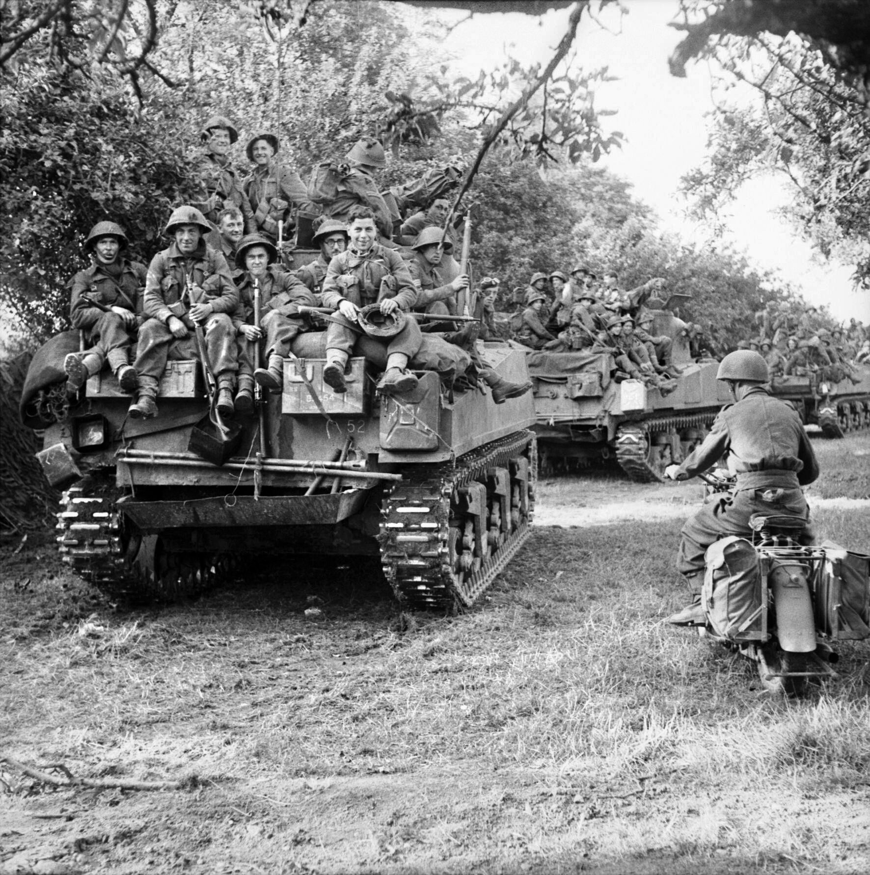 Infantrymen of the 3rd British Division ride atop tanks of the Staffordshire Yeomanry, 27th Armoured Brigade, at the start of Field Marshal Montgomery’s Operation Goodwood, July 18, 1944. Becker’s mobile artillery batteries stalled British attempts to break out of the Normandy beachhead. 