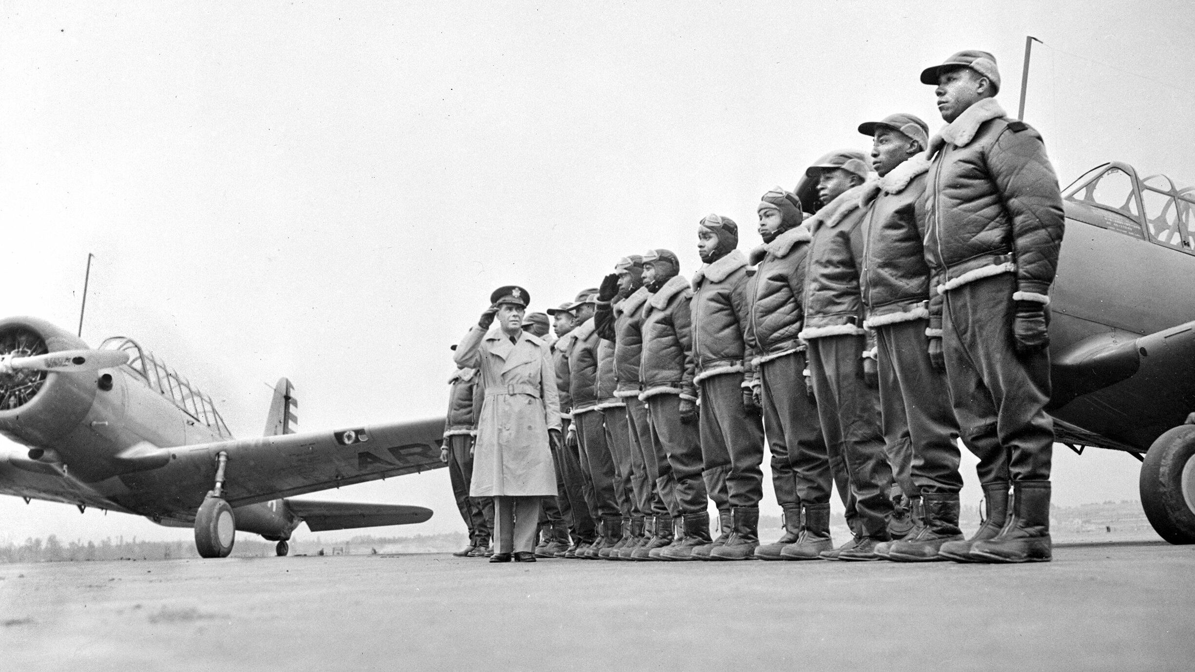 Major James Ellison (left) reviews the first class of cadets at Moton Field on January 23, 1942. The men faced harsh discrimination by whites, both on and off the base. 