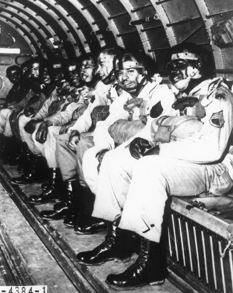 Paratroopers prepare to “stand up and hook up” before leaping out of their plane. 