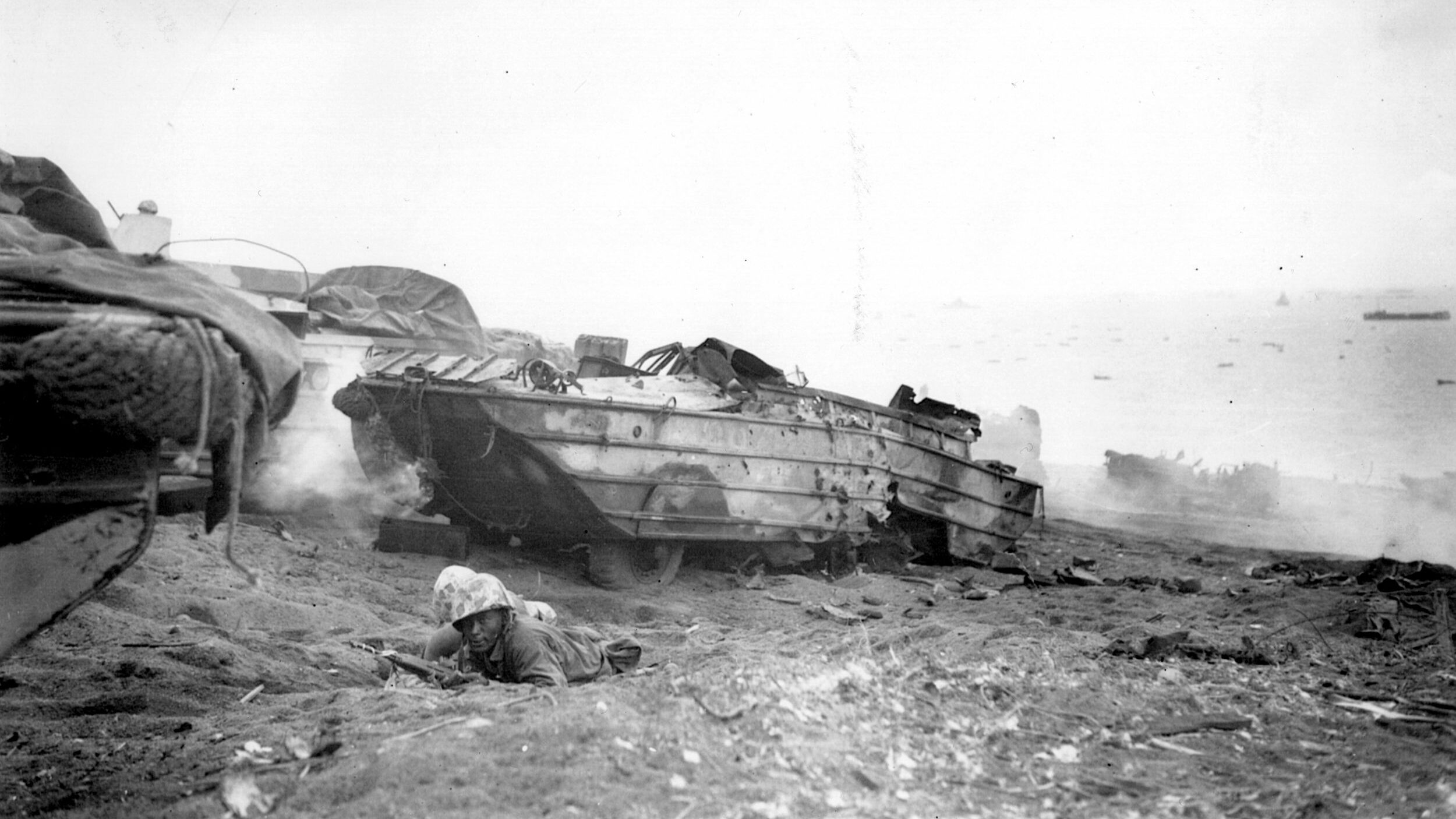 Marine Duck drivers take up arms on Iwo Jima after their vehicle was struck by enemy fire. 