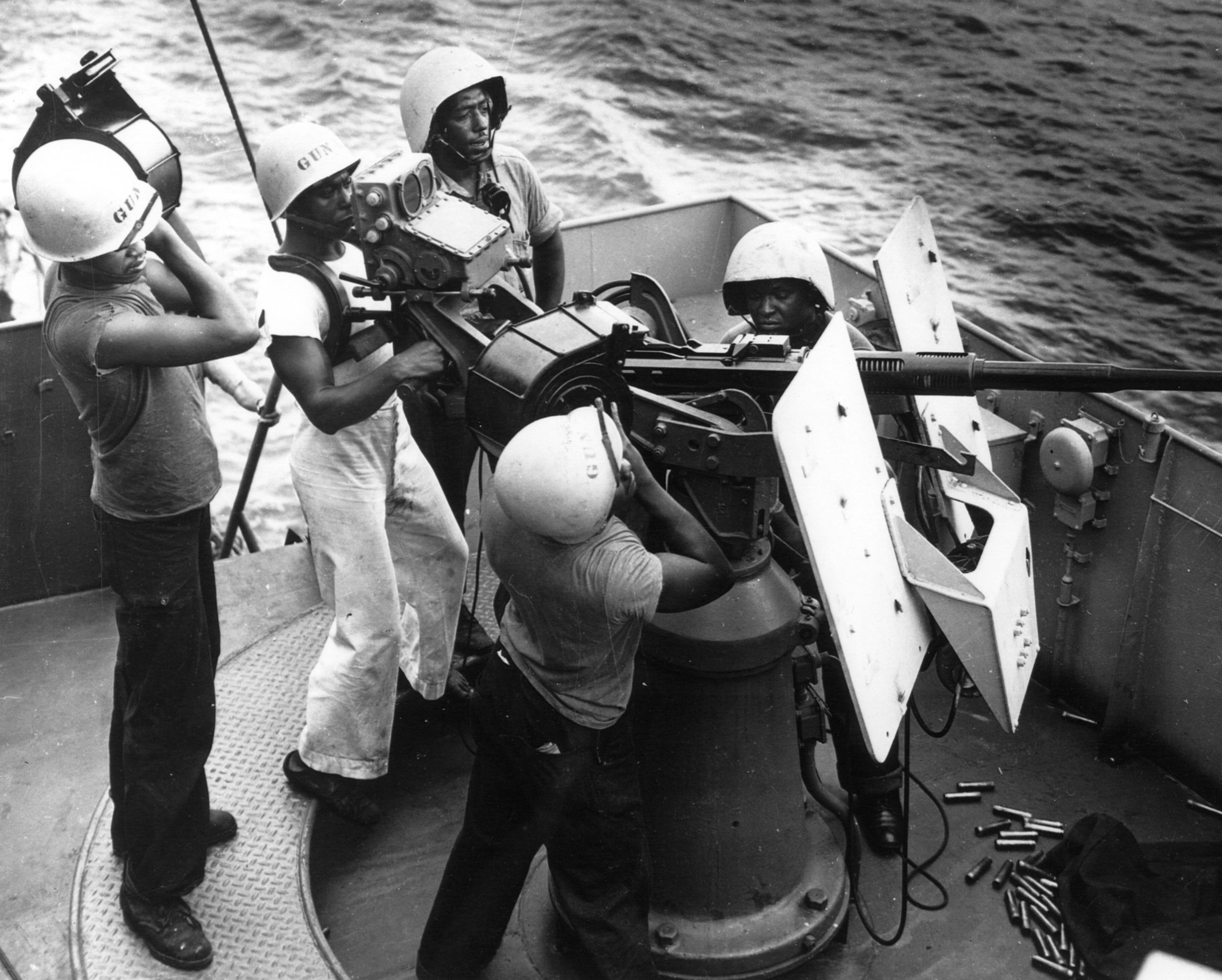 Five Coast Guard Steward’s Mates man a 20mm antiaircraft gun during a battle stations drill.