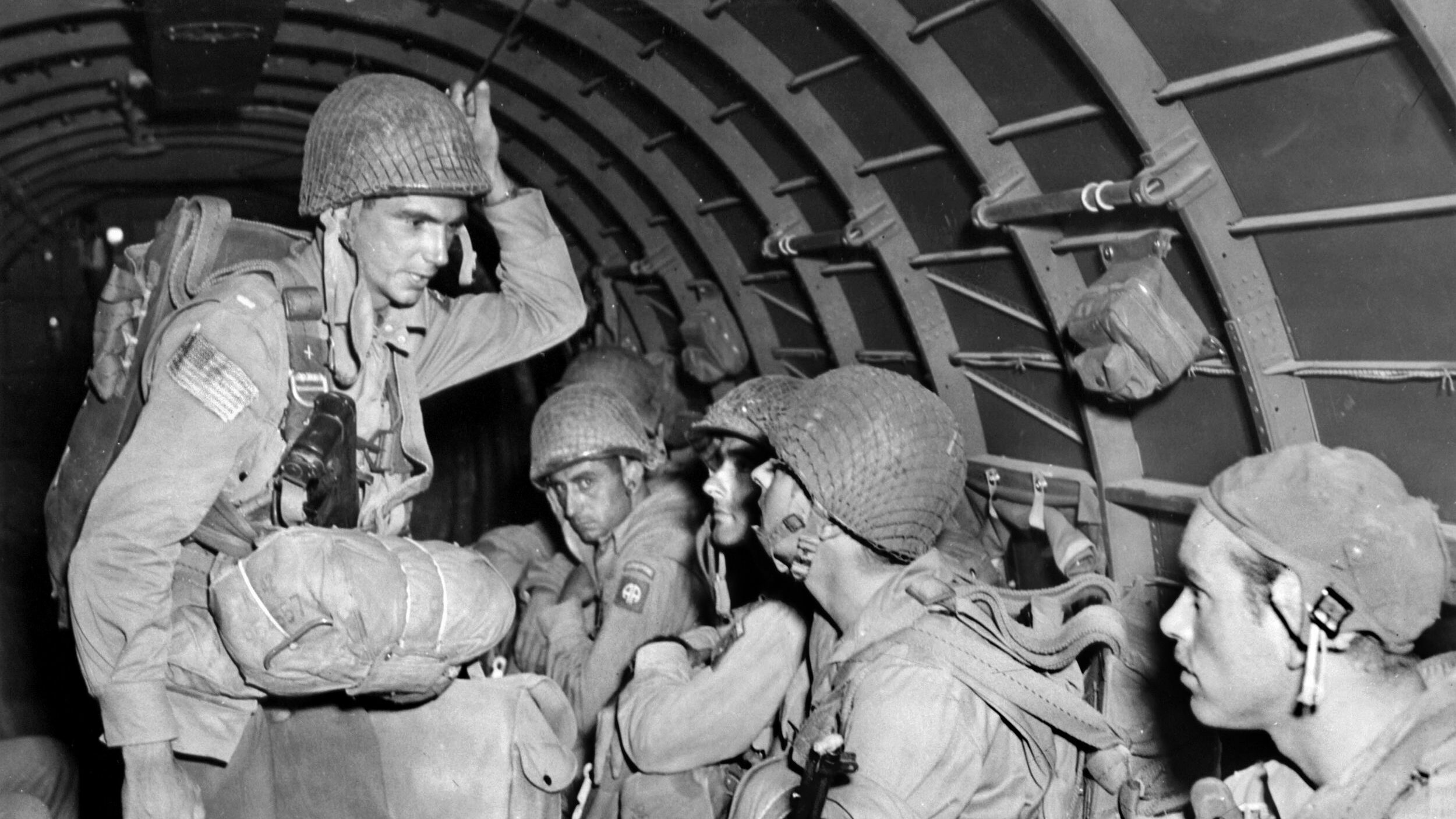 Paratroopers of the 82nd Airborne Division ride aboard a transport aircraft en route to their drop zones near the Salerno beachhead during the Allied invasion of the Italian mainland September 13-14, 1943. Members of the 504th and 505th Parachute Infantry Battalions were dropped to support the push inland. Members of the509th were deployed behind enemy lines to break up German communications at Avellino.