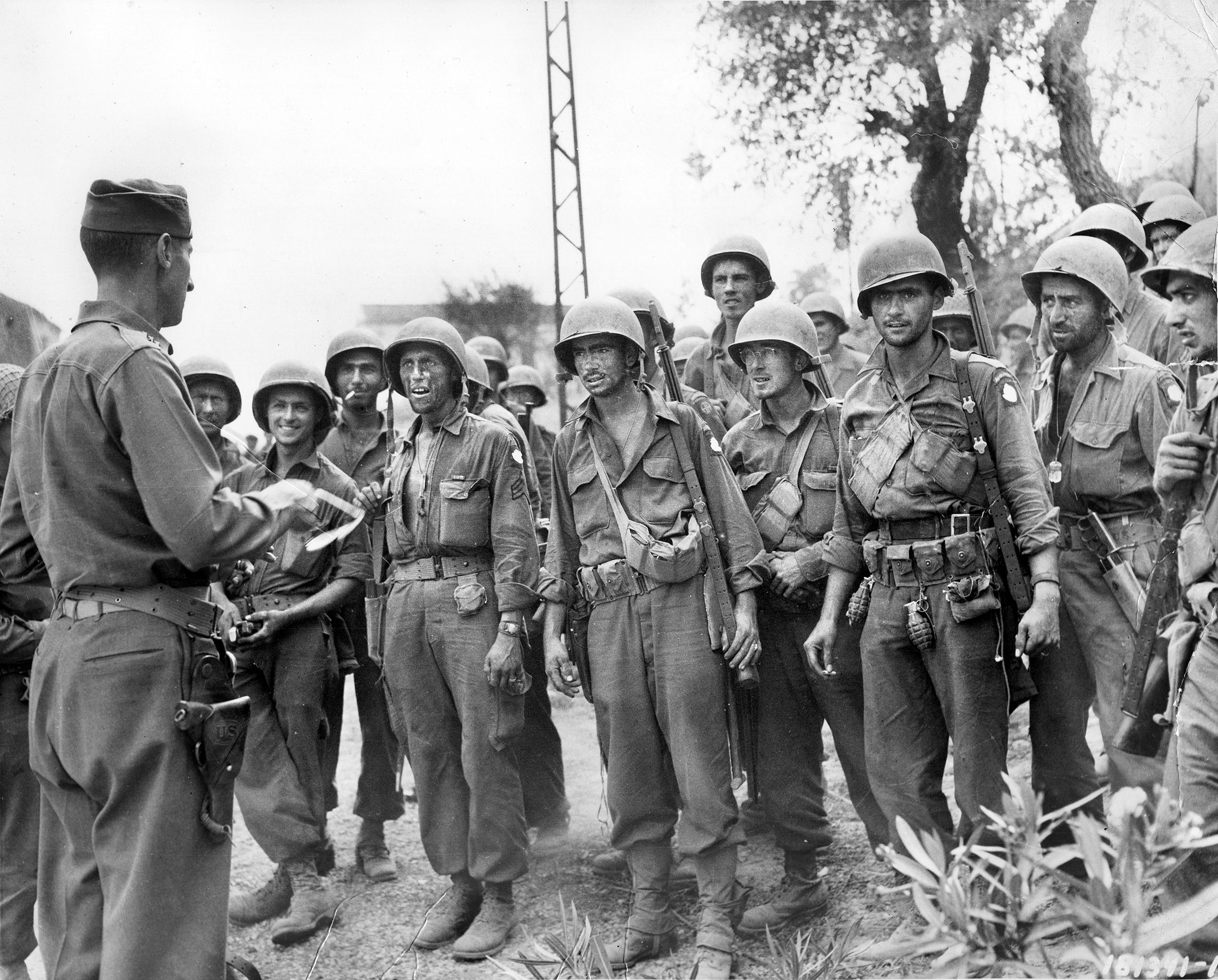General Mark W. Clark, commander of the Allied Fifth Army at Salerno, briefs troopers of the 82nd Airborne Division prior to a mission during the invasion of the Italian mainland in late 1943. The Salerno beachhead was threatened but held against repeated German counterattacks.