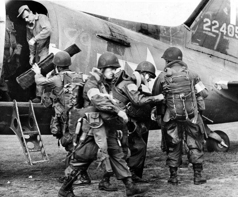 Wearing American flag armbands so that Dutch civilians can easily identify them, American paratroopers load their C-47 transport plane just before taking off on September 17, 1944, opening day of Operation Market-Garden, the combined airborne/ground offensive into the Netherlands.