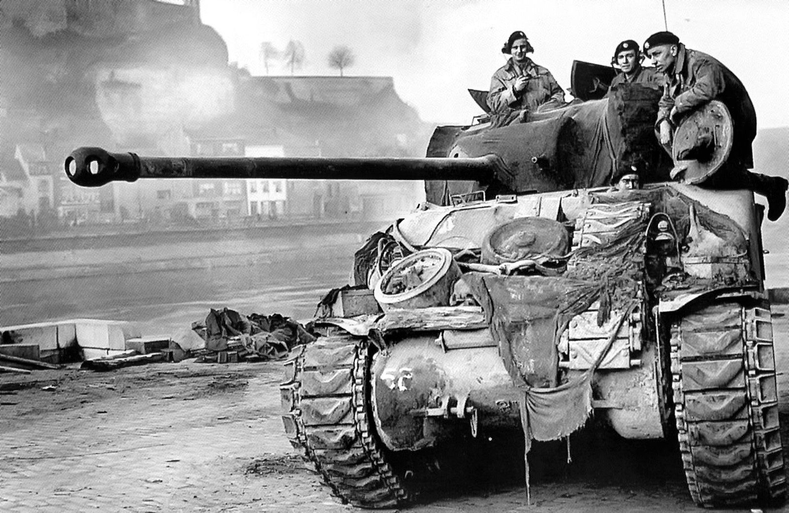 Crewmen pause in the chassis and turret of a Sherman Firefly tank of the British Coldstream Guards during the ground advance into the Netherlands. Six Fireflies, modified from the original Sherman configuration to carry a 17-pounder gun and belonging to the 1st Battalion, Coldstream Guards helped Company B, 505th Parachute Infantry Regiment repulse a German attack on the Heumen Bridge. 