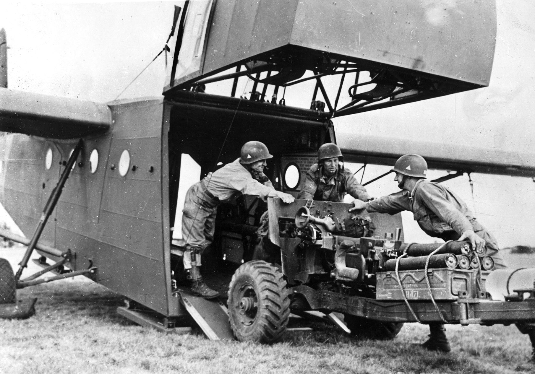 American airborne soldiers load a 57mm anti-tank gun through the nose of a glider in preparation for Operation Market-Garden. During the fighting in the Netherlands, the U.S. 82nd Airborne Division received three full battalions of airborne field artillery and two batteries of 57mm anti-tank guns for fire support.