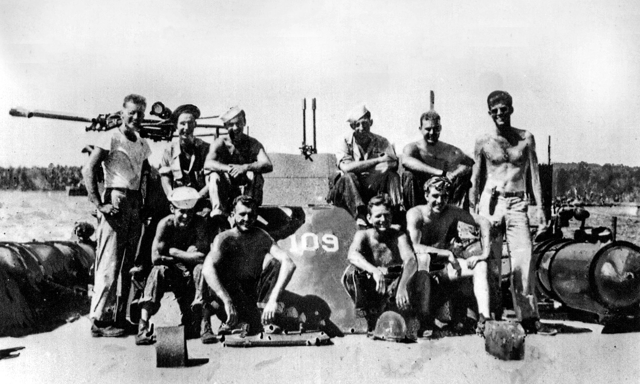 Posing with crewmen of the PT-109 at a South Pacific naval base, Lieutenant John F. Kennedy smiles at far right. This photo was taken in 1943 not long before the fateful encounter with the Japanese destroyer Amagiri in Blackett Strait.