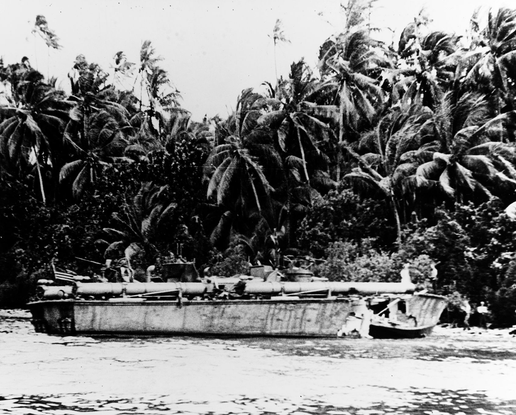  With a gaping hole in her bow after a Japanese air raid, PT-117 lies beached at Rendova on August 1, 1943. PT-boats saw heavy action during the campaign in the Solomon Islands.