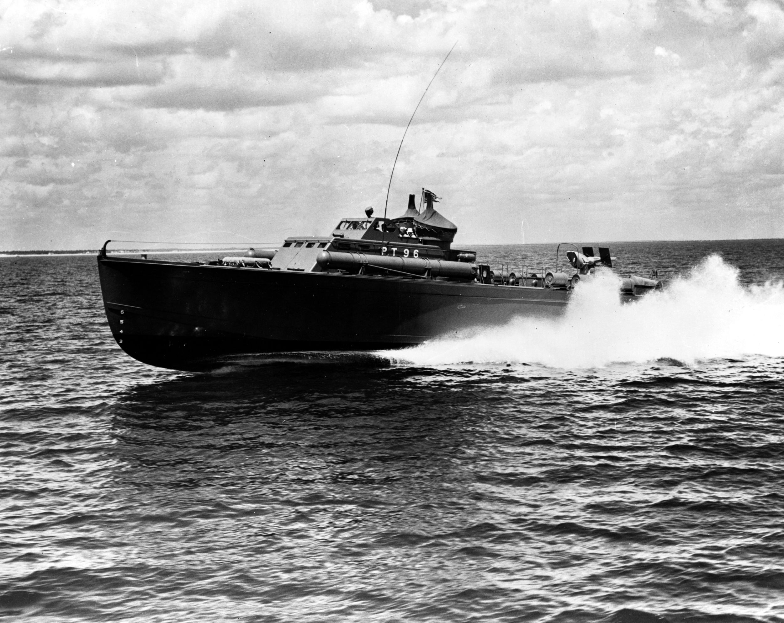 Underway at high speed, PT-96 demonstrates the swiftness of the light patrol craft. Note the external torpedo tube visible on deck. This photo was taken in 1942.