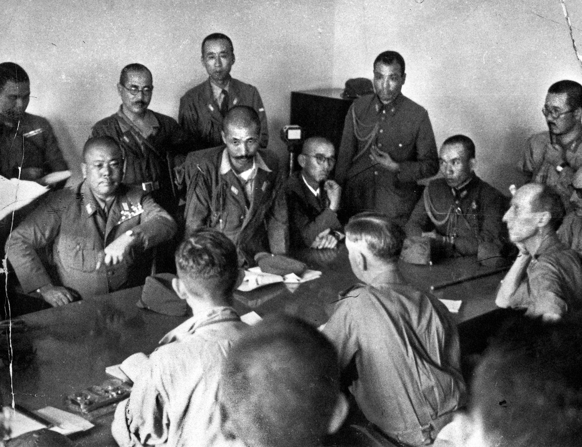 General Tomoyuki Yamashita, commander of the Japanese 25th Army, pauses as he dictates terms of the surrender of Singapore to General Arthur Percival. 