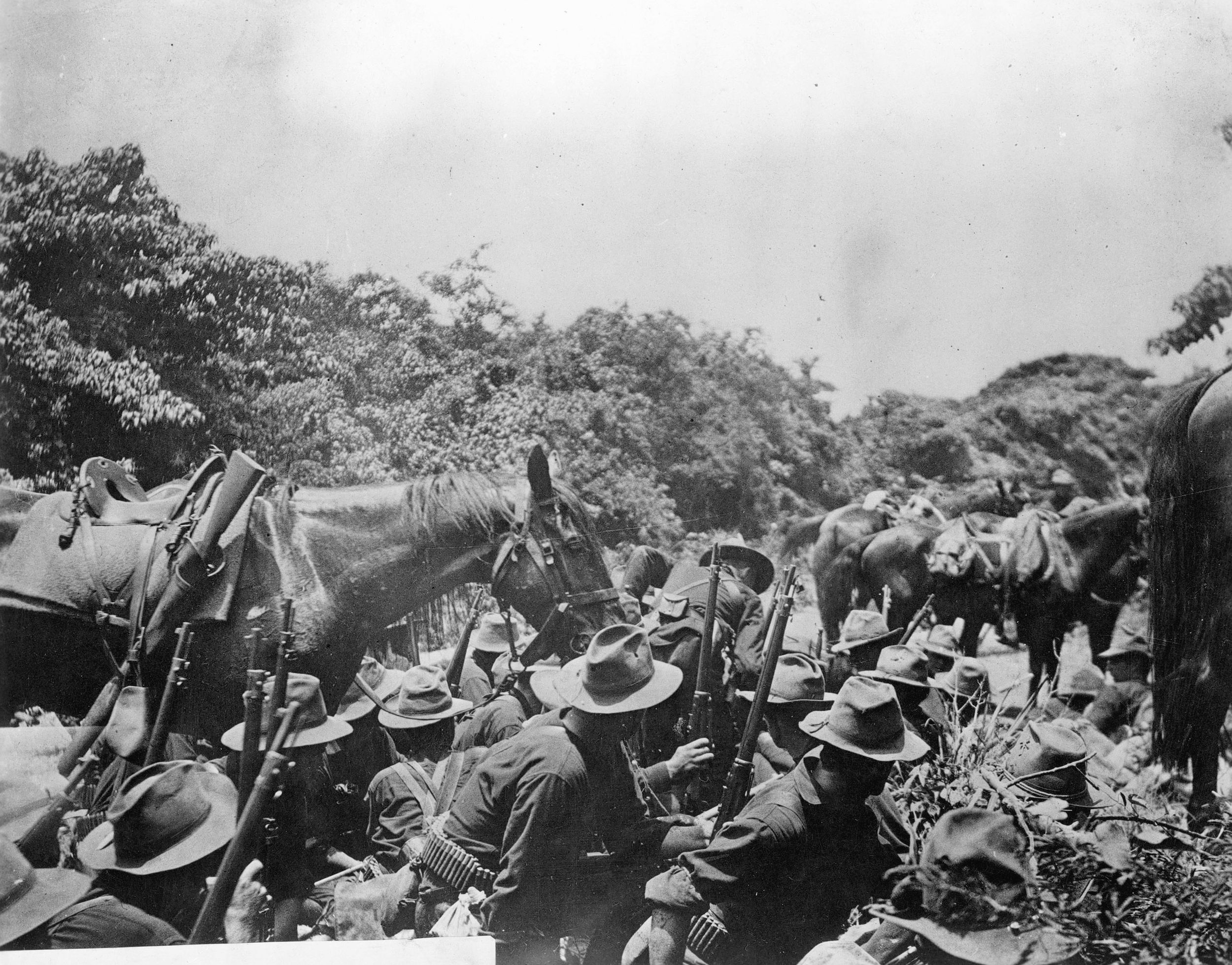 Troops of the 16th Infantry take fire in the perilous San Juan River bottom. Most American casualties were suffered here prior to the charge on Kettle and San Juan Hills.
