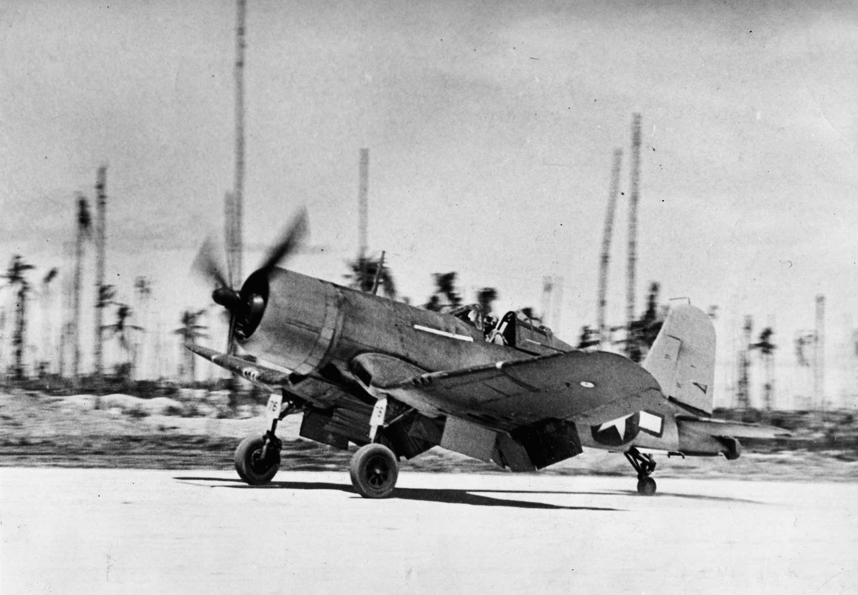 The first Allied aircraft to land after the island of New Georgia was captured from the Japanese, a U.S. Navy F4U Corsair fighter touches down on a newly operational airfield. (National Archives)