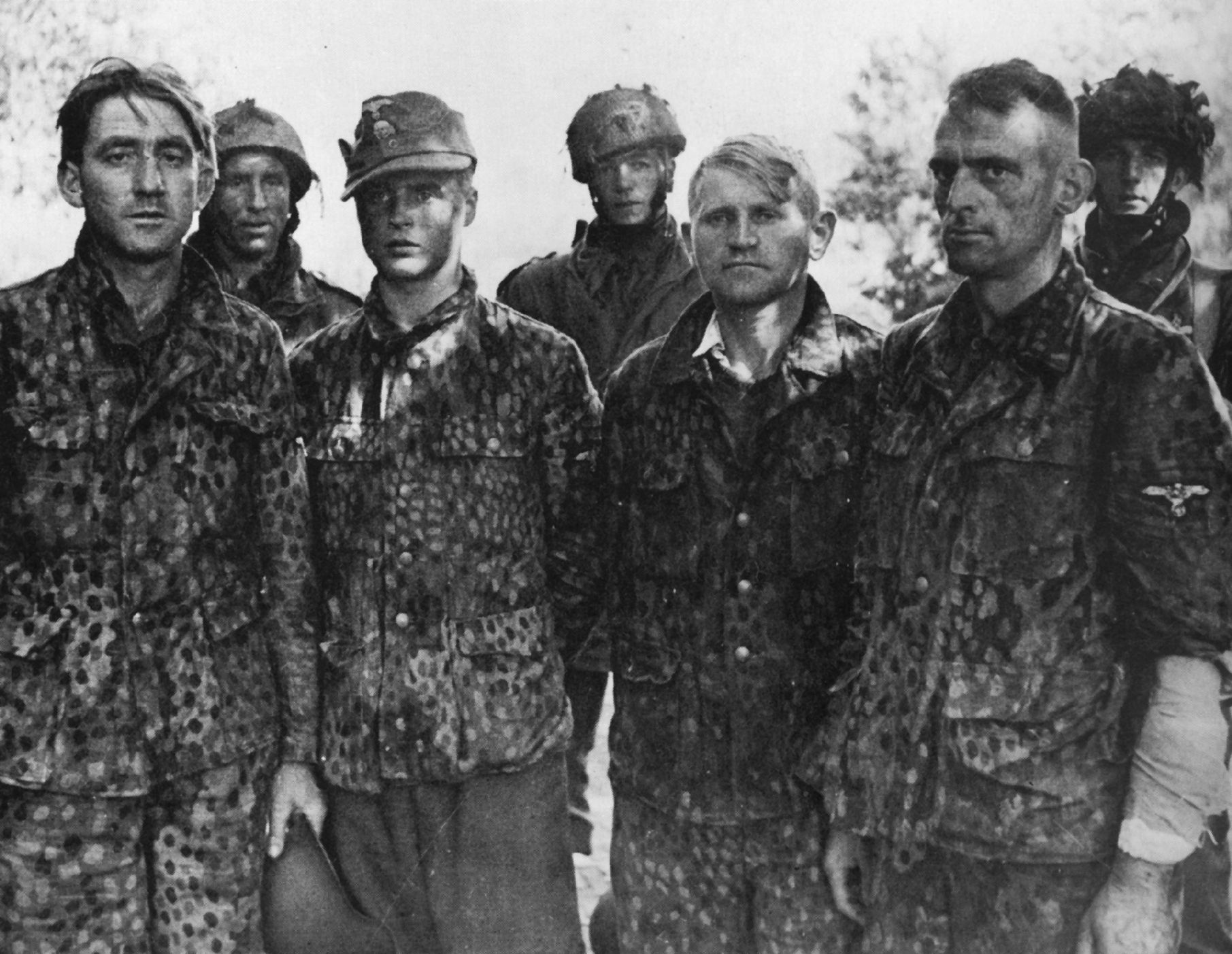 Paratroopers of the British 6th Airborne Division pose for the camera with several captured members of the SS who escaped from prison in Great Britain. (National Archives)