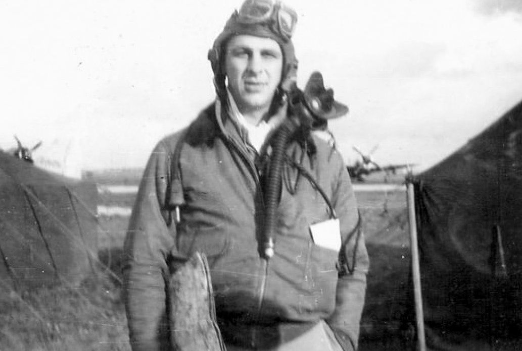 First Lieutenant Grant G. Stout poses at a 365th Fighter Group base in Europe in late 1944 or early 1945. “Map in hand, poop in pocket, and raring to go,” he wrote on the back of the original snapshot.