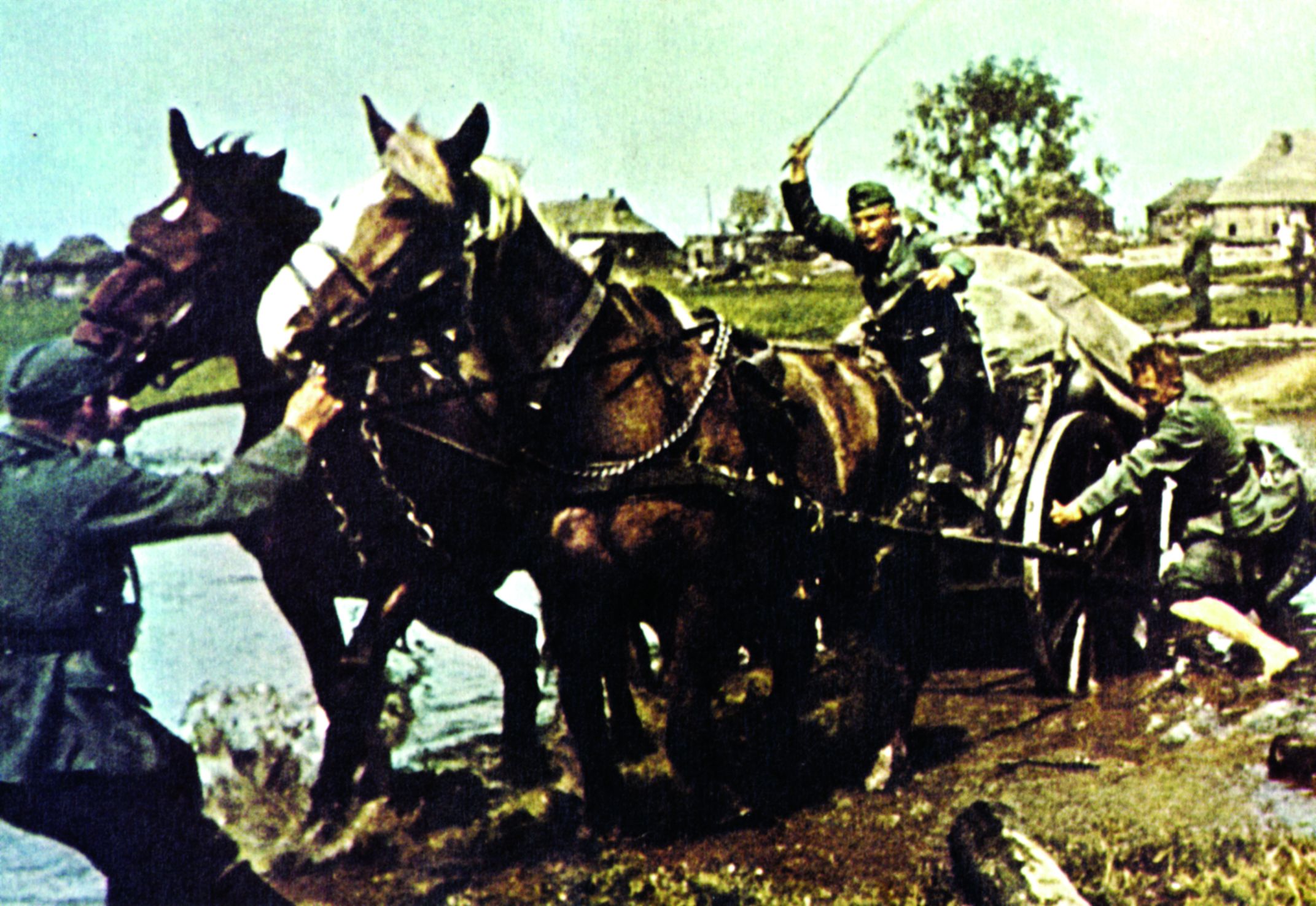 Mired in mud up to its axles, a German supply wagon is caught in the quagmire of a Russian road. Soldiers attempt to push, pull, and exhort the pair of horses drawing the wagon to extricate it from the trap caused by the spring snow thaw and heavy rain. (National Archives)