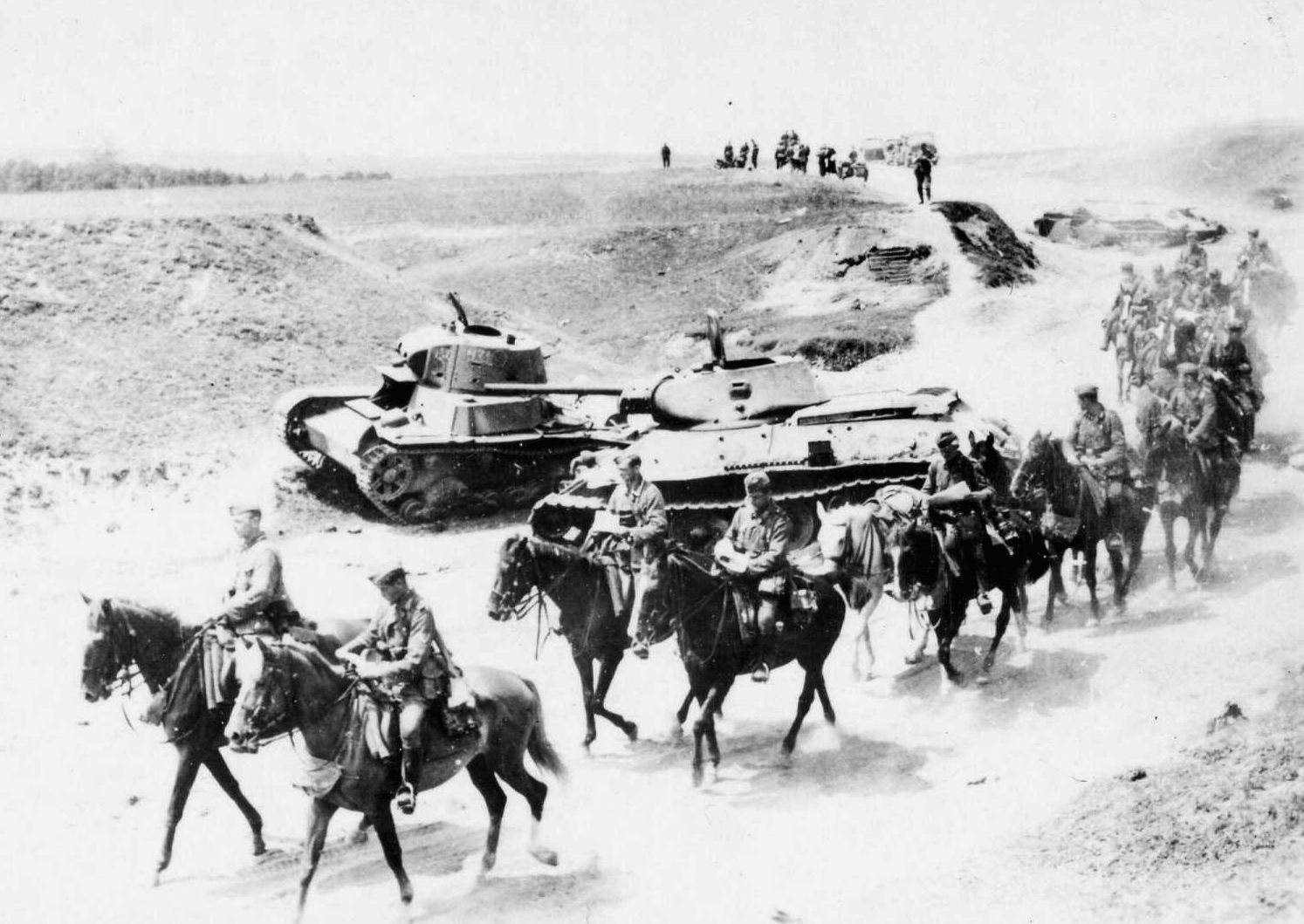 During the spectacularly successful Wehrmacht offensive of the summer of 1941, German mounted infantrymen advance past Soviet tanks that were knocked out in earlier combat. Later, the horses would suffer greatly during the terrible Russian winter. (National Archives)