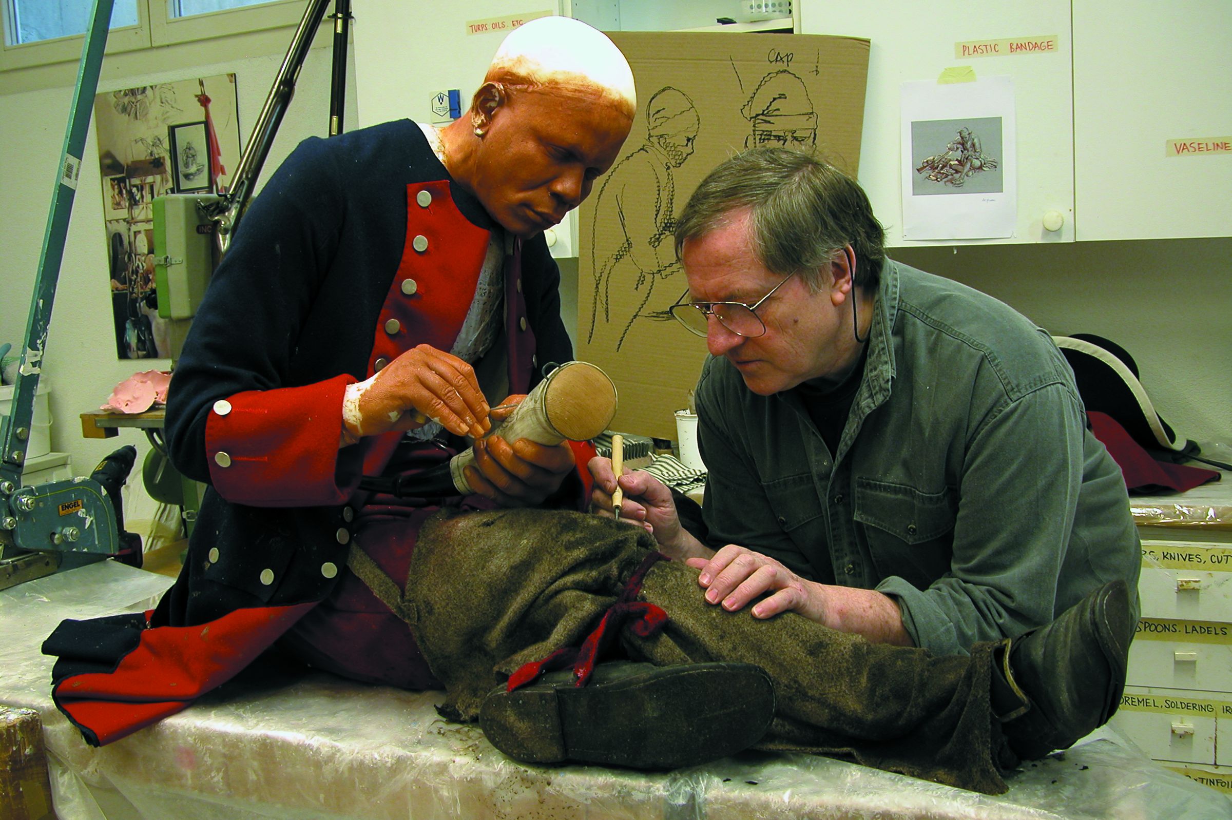 Gerry Embleton works on a figure of powder horn maker and company clerk John Bush, an African American soldier from Massachusetts who was captured at the fall of Fort William Henry and died in captivity.