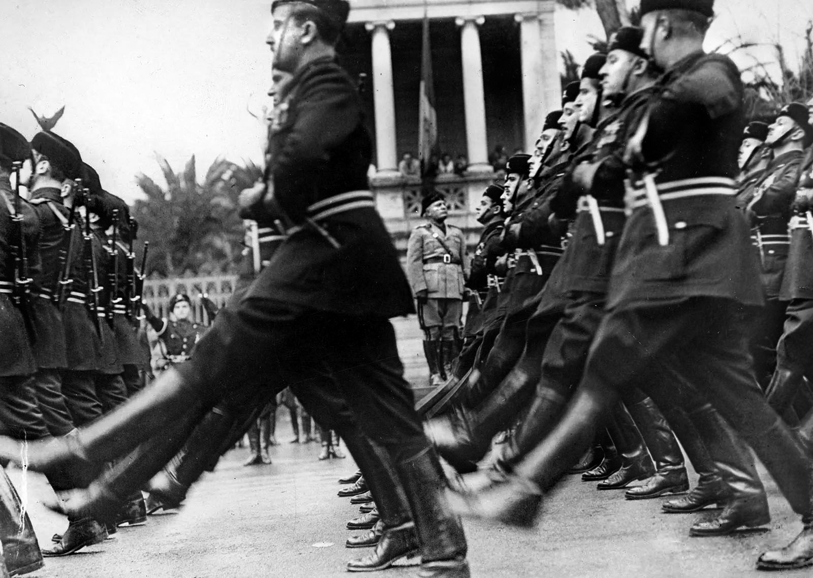 Italian dictator Benito Mussolini (center) reviews his goose-stepping troops during a parade in Rome early in the war when fortunes were smiling on the Axis powers.
