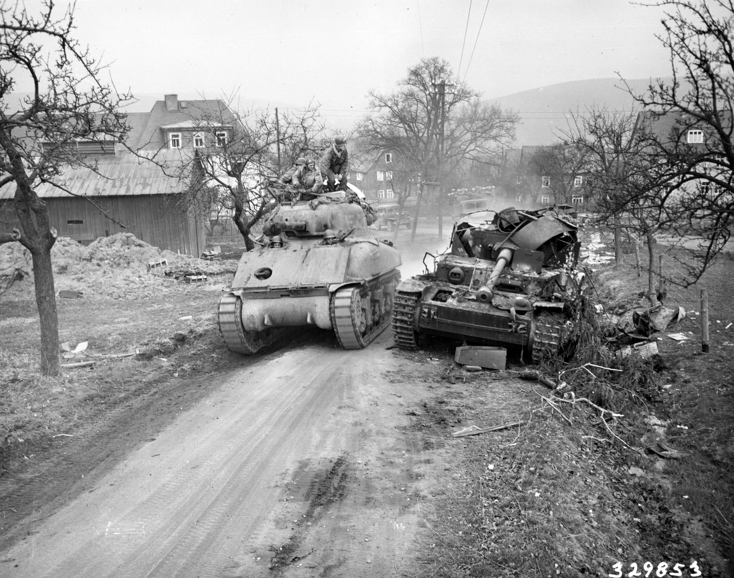 Crewmen of a 3rd Armored Division M4 glance at the burned and blasted remains of a Pz.Kpfw IV tank near Marienburg, Germany, March 28, 1945. The Germans could not match the Americans’ ability to repair their tanks and quickly get them back into action.