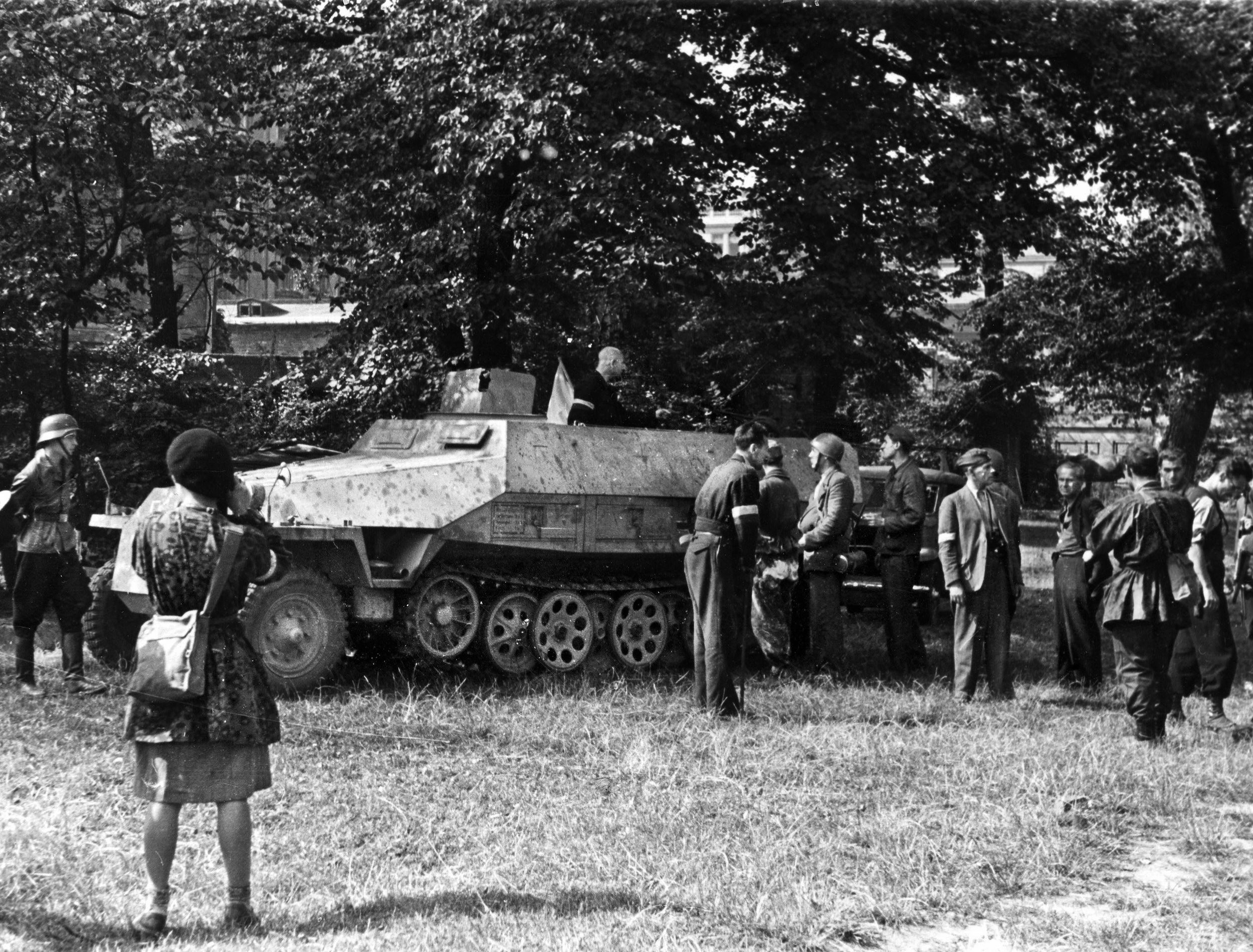Polish reporters and a film crew (right) look over a German SdKJtz 25 halftrack on display in Warsaw's Okolnik Gardens. It was captured by the Poles from the 5th SS “Viking” Division early in the fighting. 