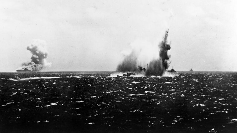 The American destroyer USS O’Brien, right, explodes near Guadalcanal, September 15, 1942 as the aircraft carrier USS Wasp burns in the distance (left). Both ships, along with the USS North Carolina, were torpedoed by Captain Kinashi Takakazu's I-19, which escaped a heavy depth-charging by other ships in the convoy.