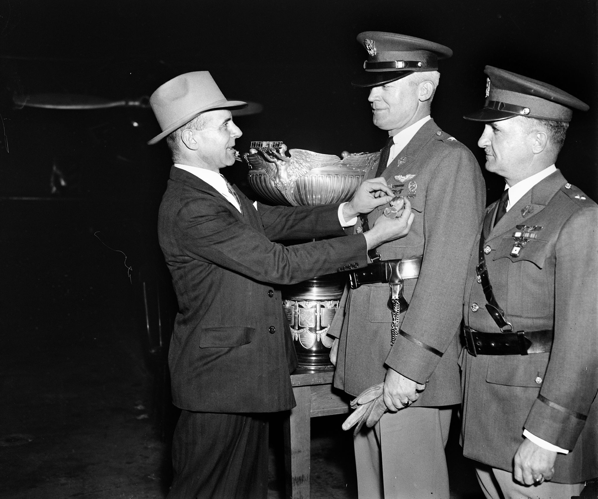 In this photograph from April 1935, Major Jimmy Doolittle (left), vice president of the National Aeronautic Association, presents Brigadier General Henry “Hap” Arnold a gold medal to honor his receipt of the Mackay Trophy. Both men went on to hold high command during World War II. General Oscar Westover, assistant chief of the Army Air Corps, looks on at right.