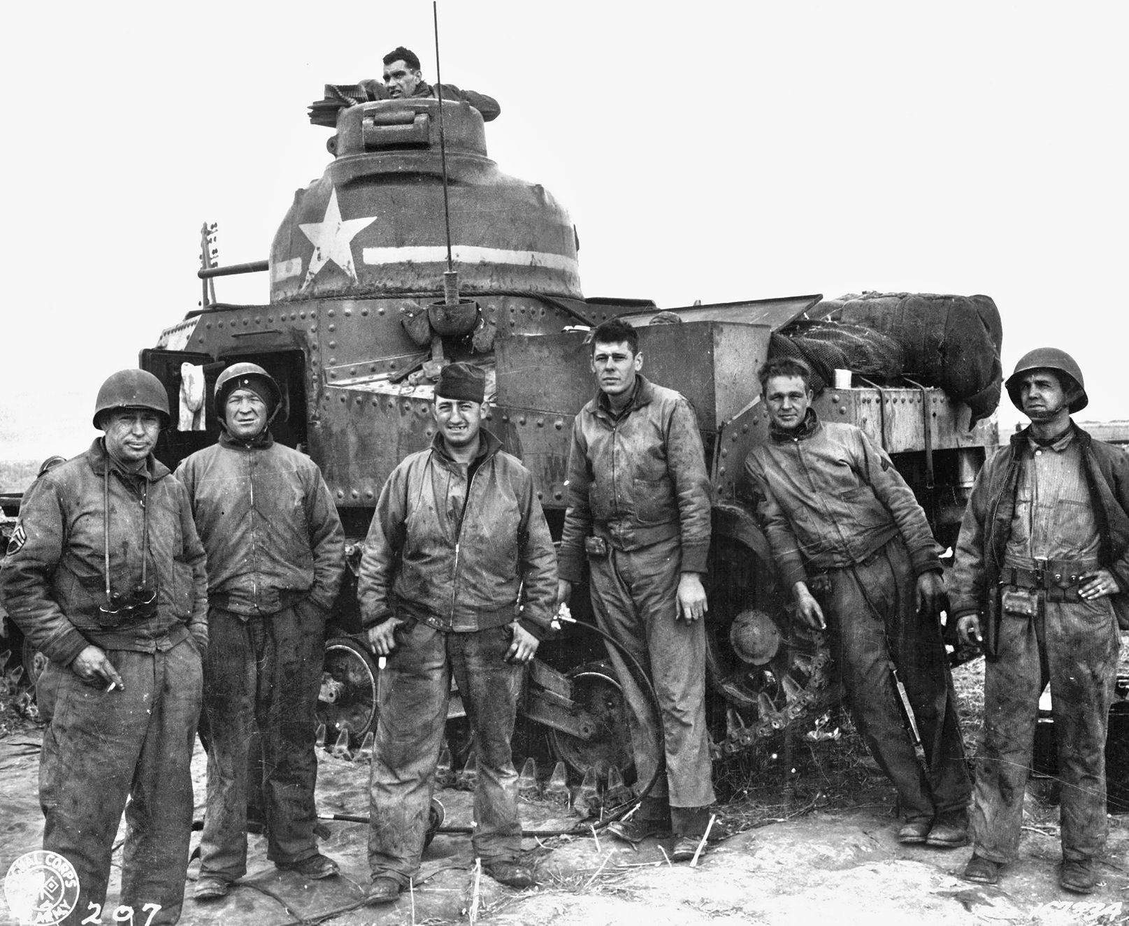 An American tank crew poses beside its M3 tank during a respite from combat in Tunisia in November 1942. The Grant tank was soon replaced by the M4 Sherman medium tank.