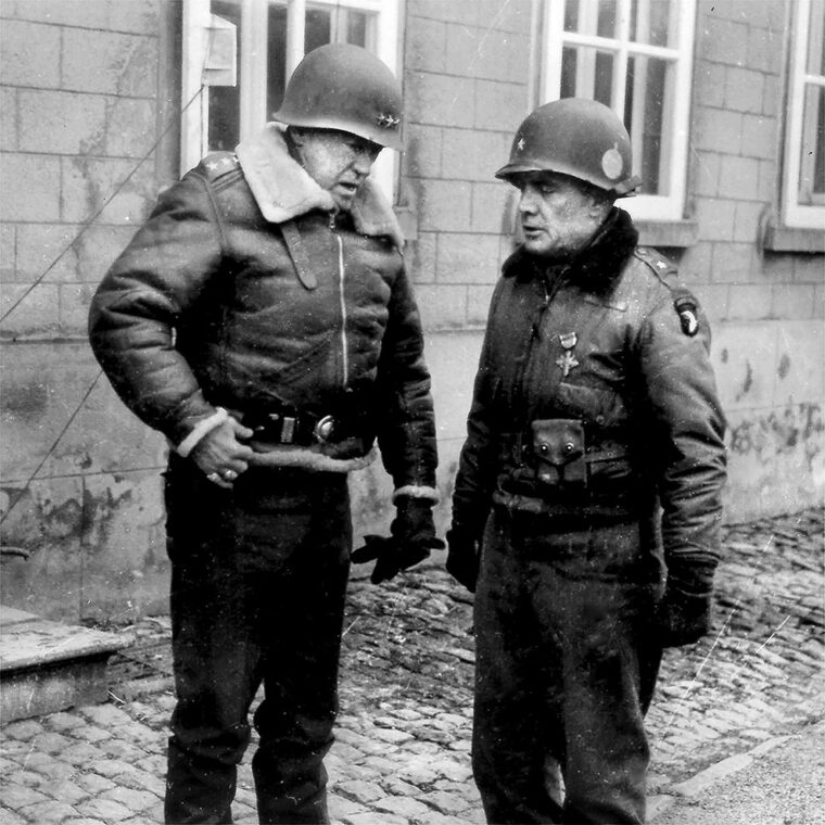 General George S. Patton, commander of Third Army (left), meets Brigadier General Anthony McAuliffe, temporary commander of the 101st Airborne Division, after the relief of Bastogne. McAuliffe gained fame with his reply “Nuts!” to a German surrender demand. 