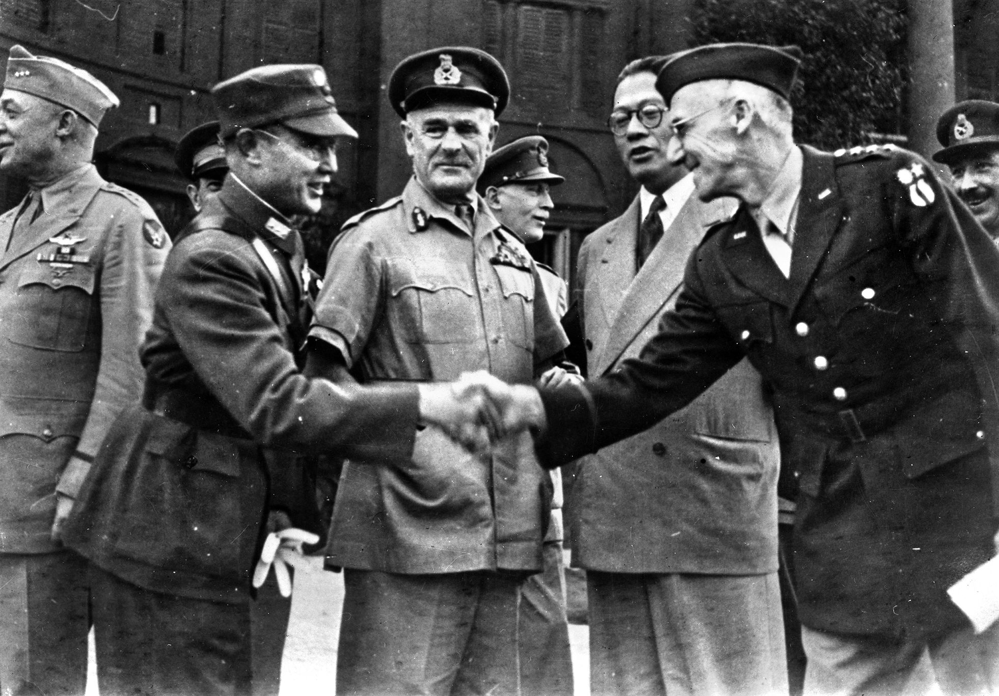 Field Marshal Archibald Wavell stands at center as Chinese General Chen Cheng and U.S. General Joseph Stilwell shake hands prior to the beginning of an Allied conference in Delhi, India.