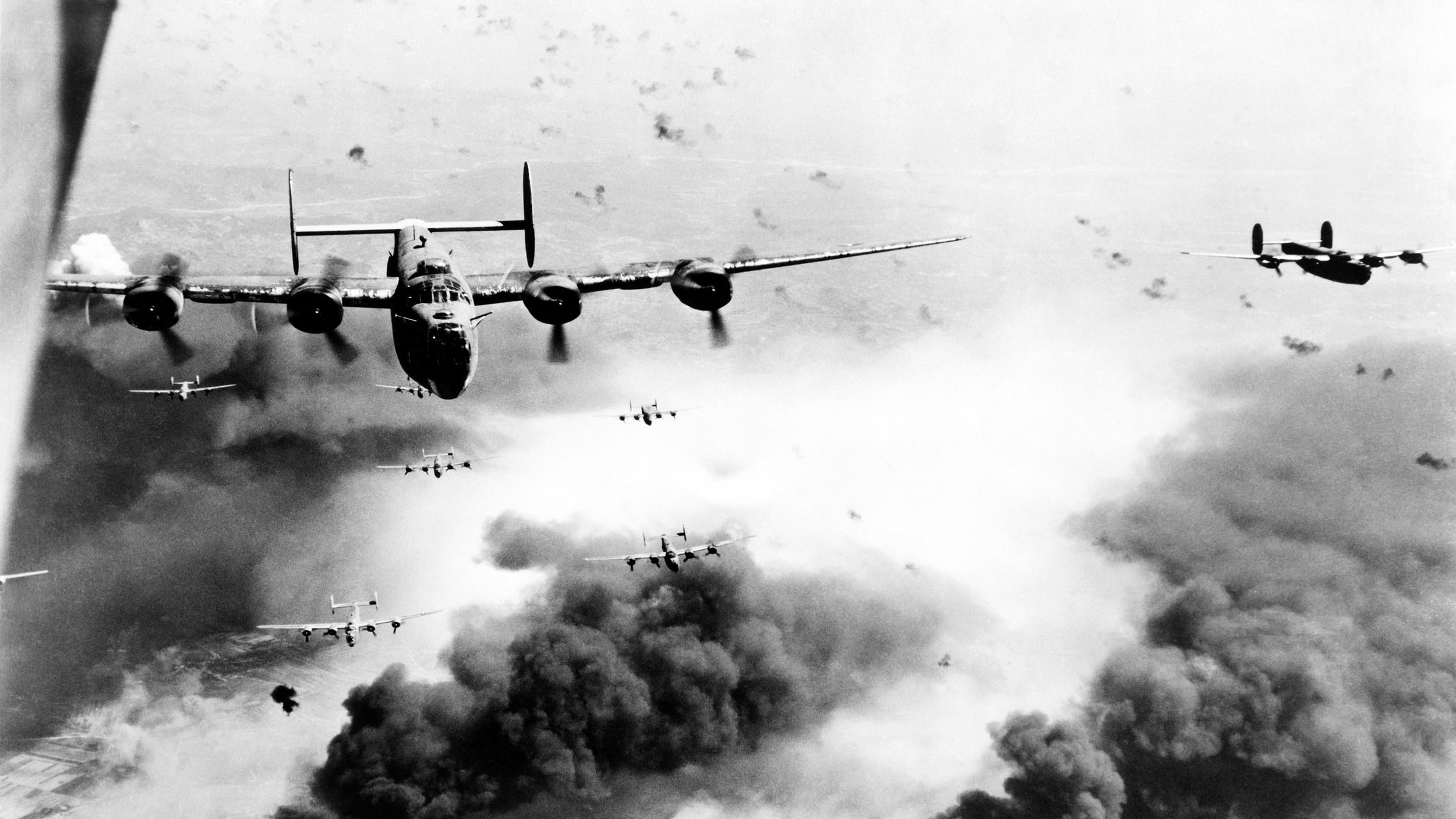 Consolidated B-24 Liberator bombers of the U.S. Fifteenth Air Force fly through thick enemy flak during bombing runs against the oil refinery complex at Ploesti, Romania. These bombers executed one of the most hazardous missions of World War II, and accurate weather information decrypted from German sources facilitated such air operations.