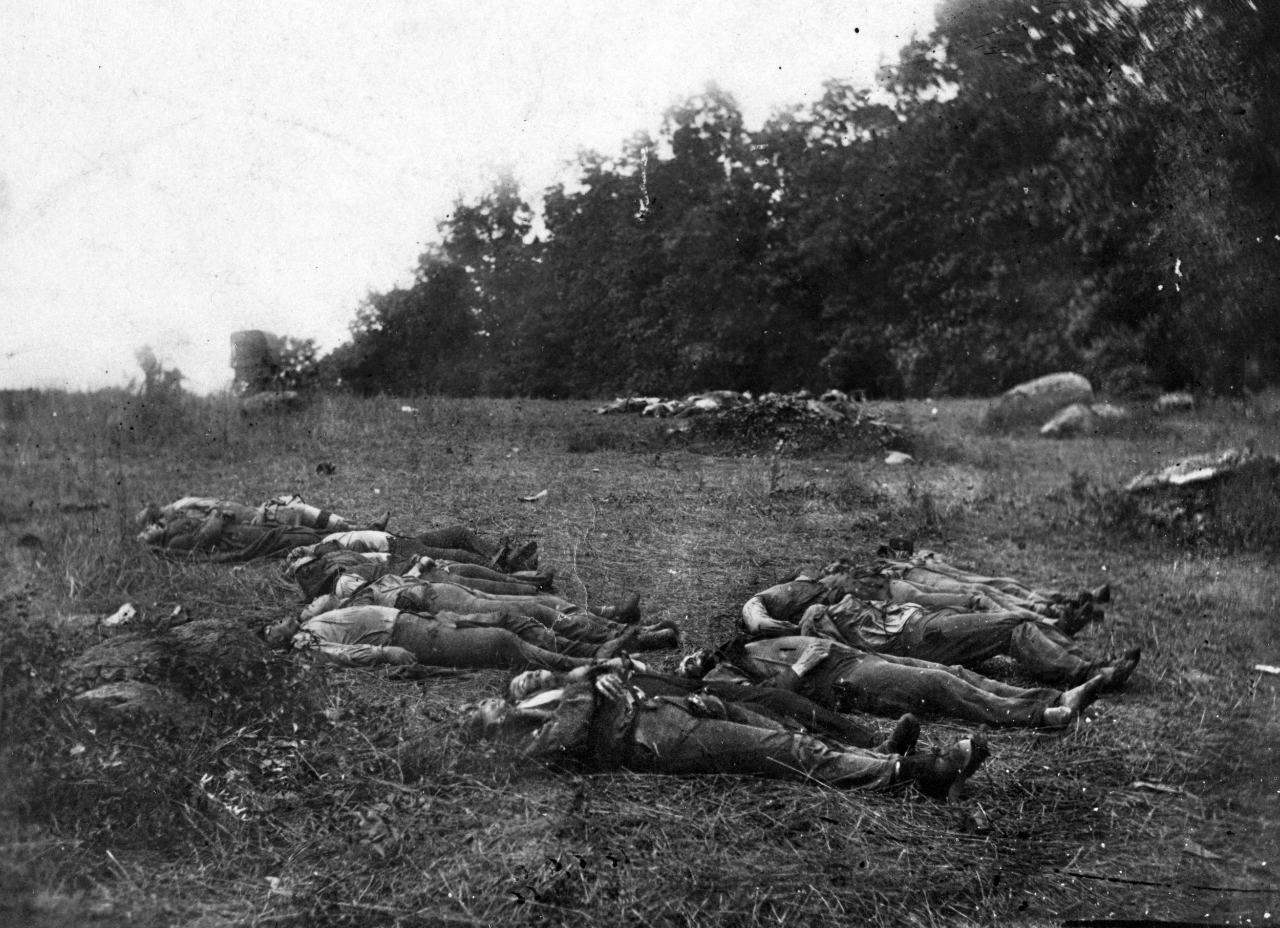 Photographer Alexander Gardner arrived in Gettysburg shortly after the battle was over and captured a number of photographs of the dead, including this image of soldiers gathered for burial in the Wheatfield.