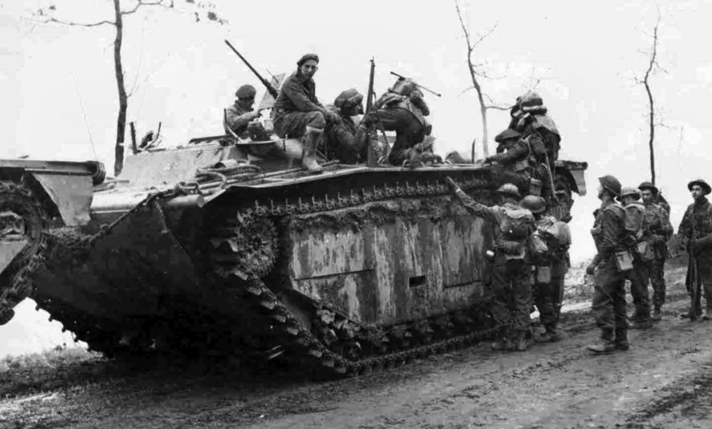 A Canadian armoured personnel carrier—”Kangaroo”—made from the modified chassis of an M4 Sherman medium tank, carries Allied soldiers during Operation Veritable.